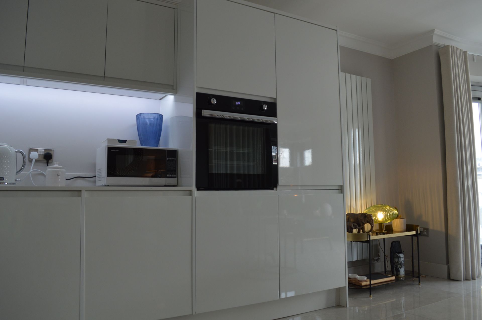 A kitchen with white cabinets and a black oven