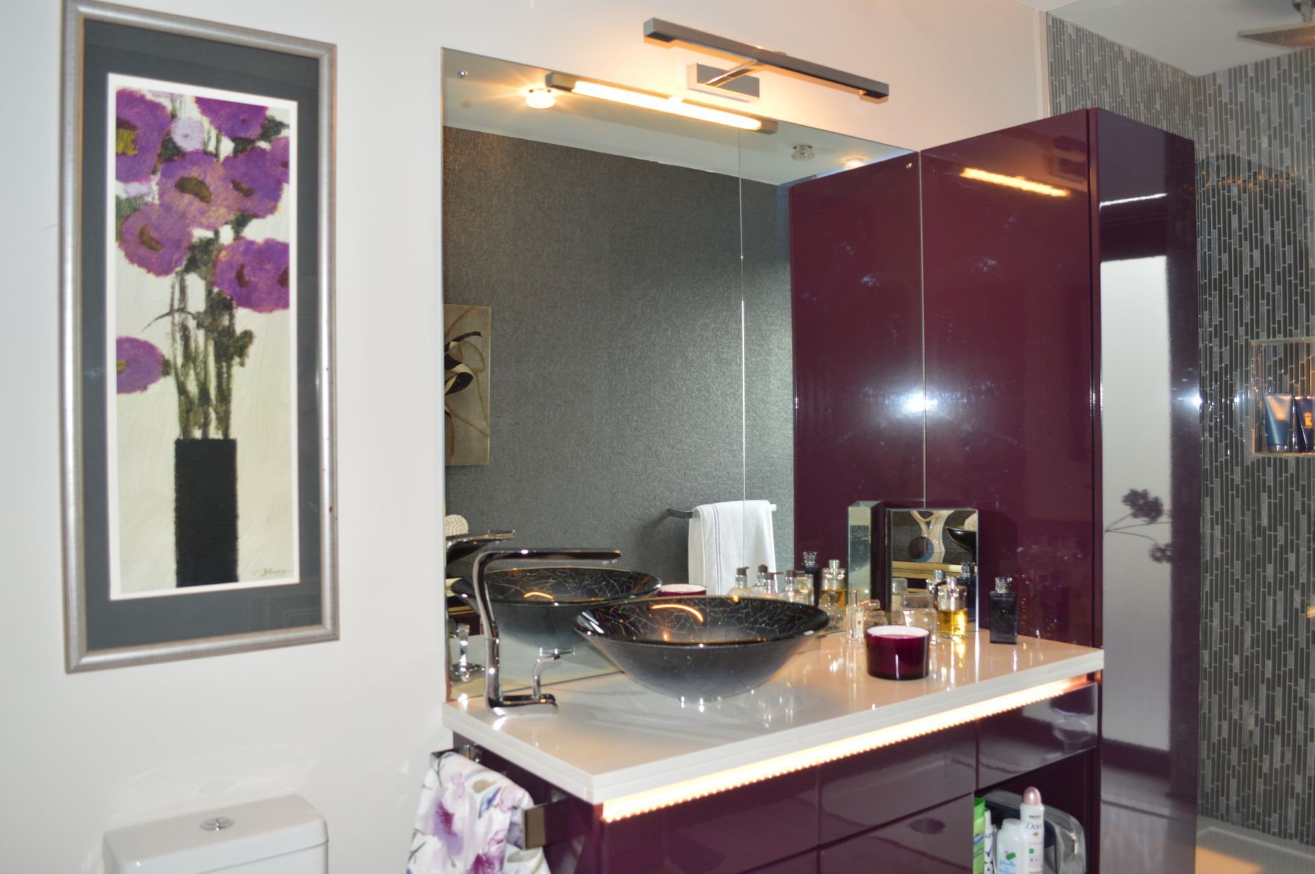 A bathroom with purple cabinets and a sink