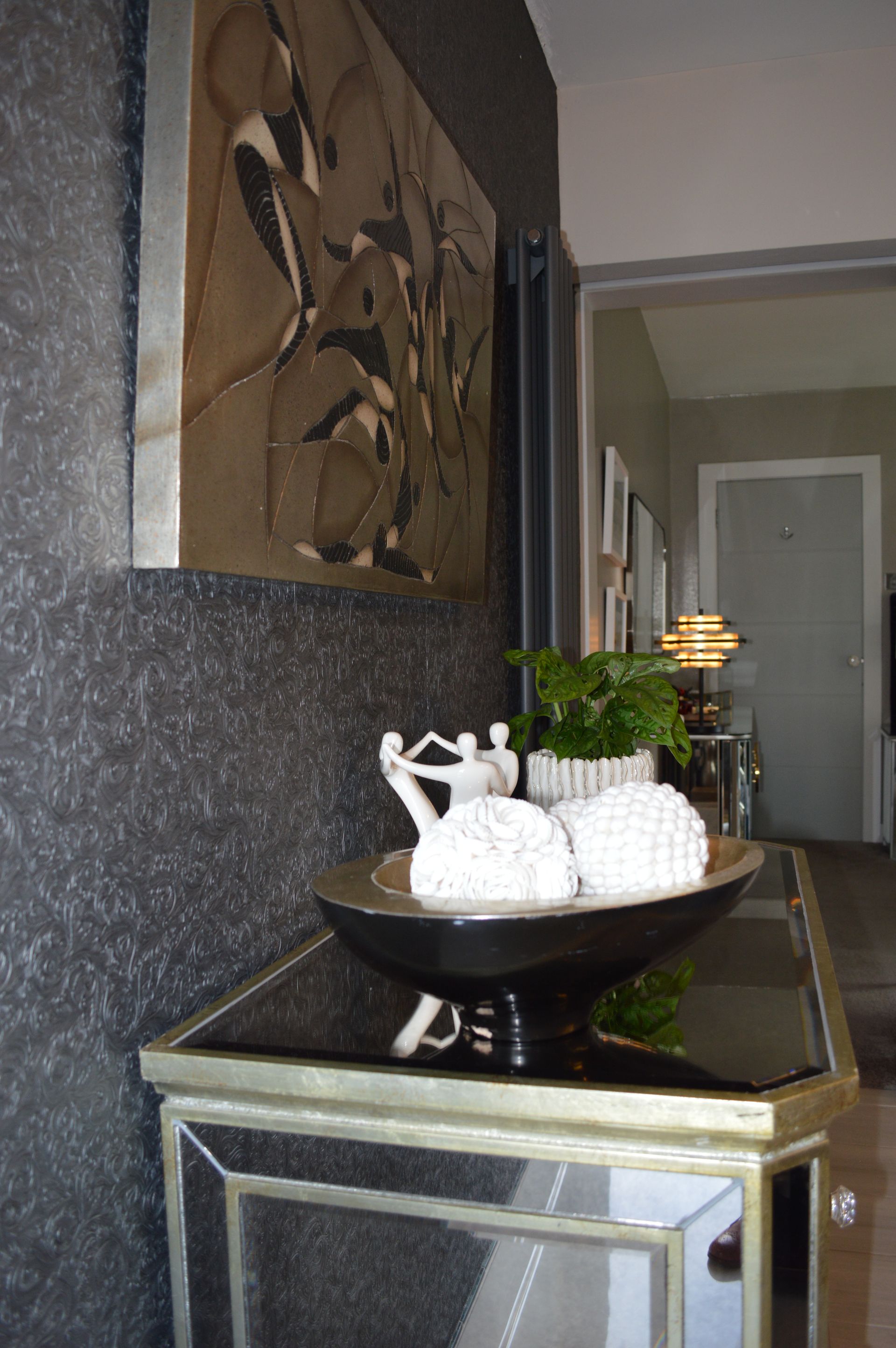 A mirrored table with a bowl on top of it