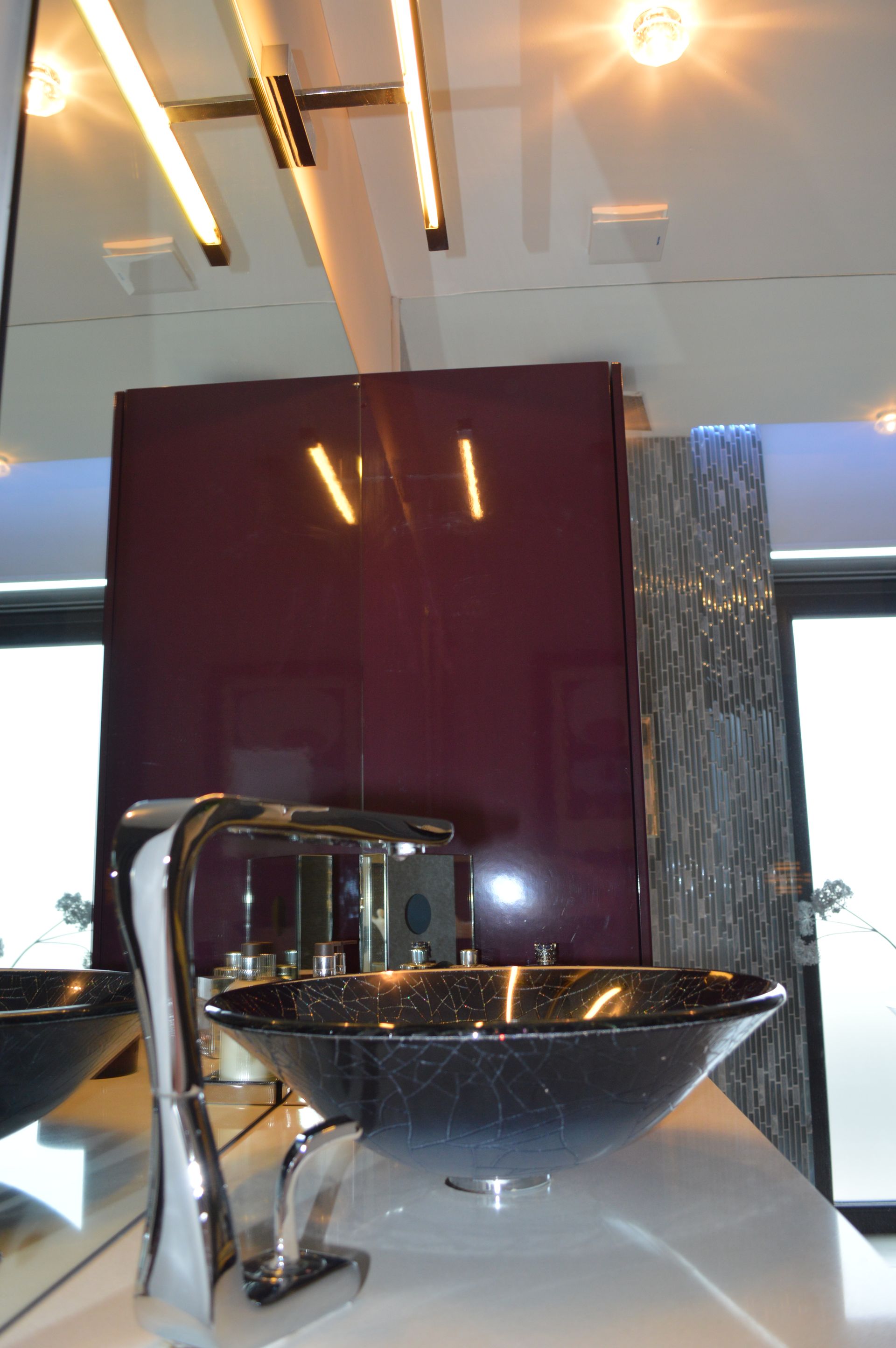 A bathroom with two sinks and a purple wall