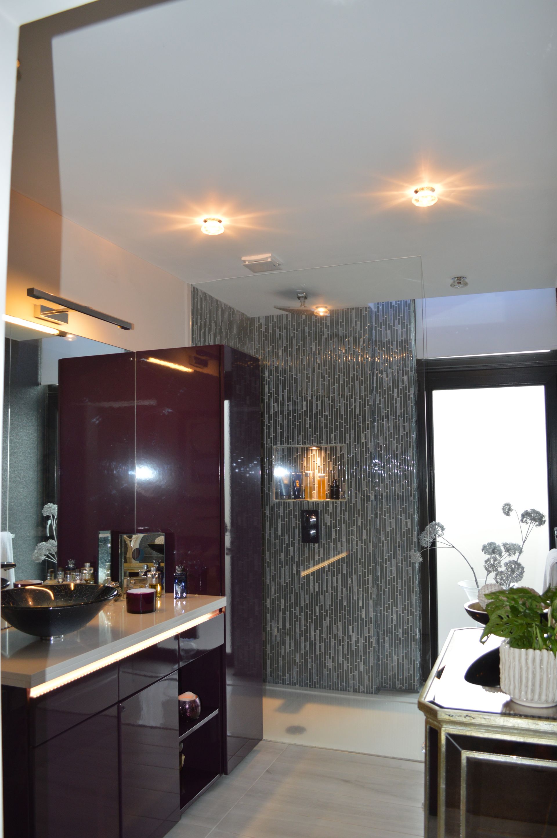 A bathroom with a sink and a walk in shower