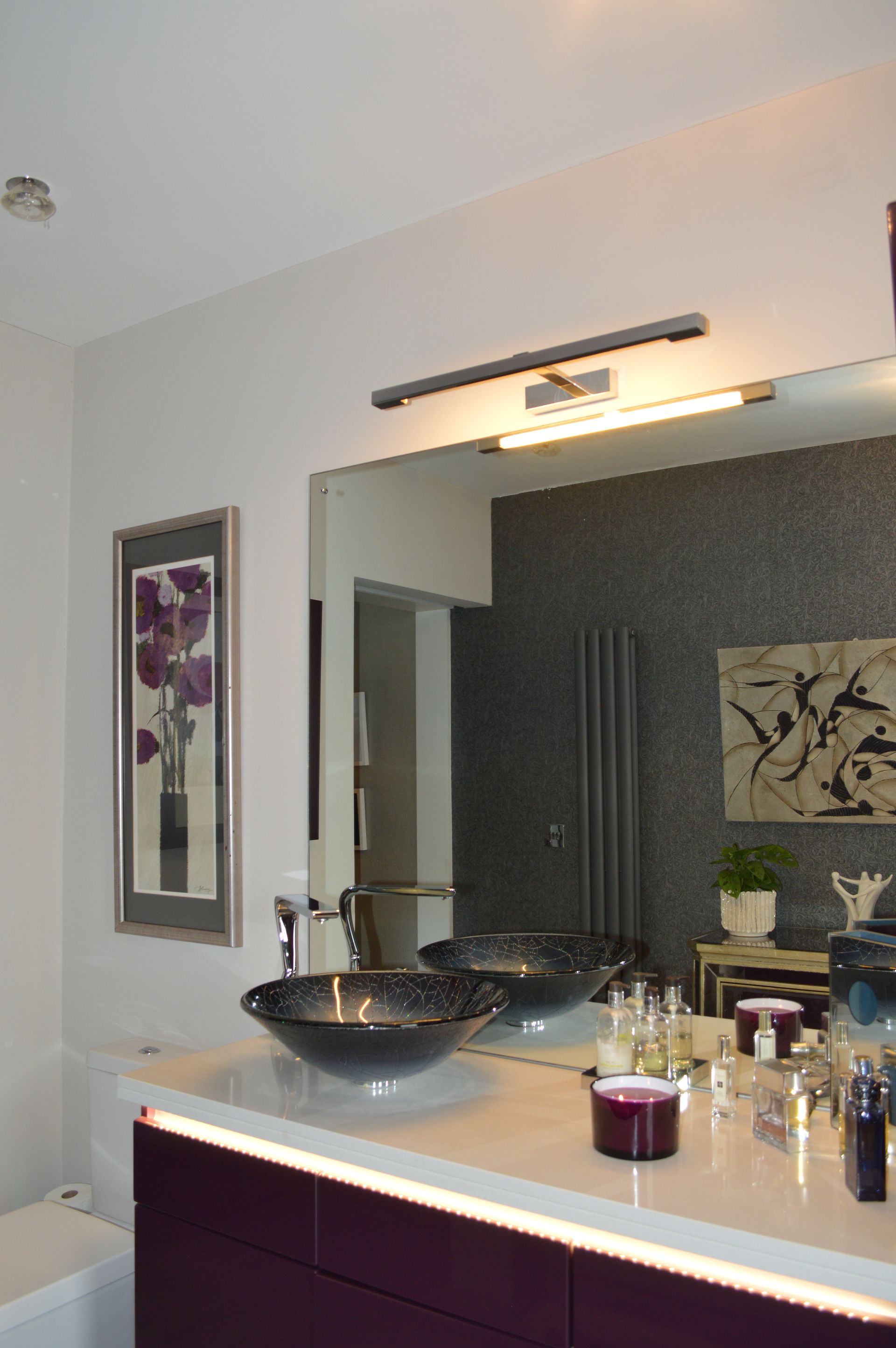 A bathroom with two sinks and a large mirror