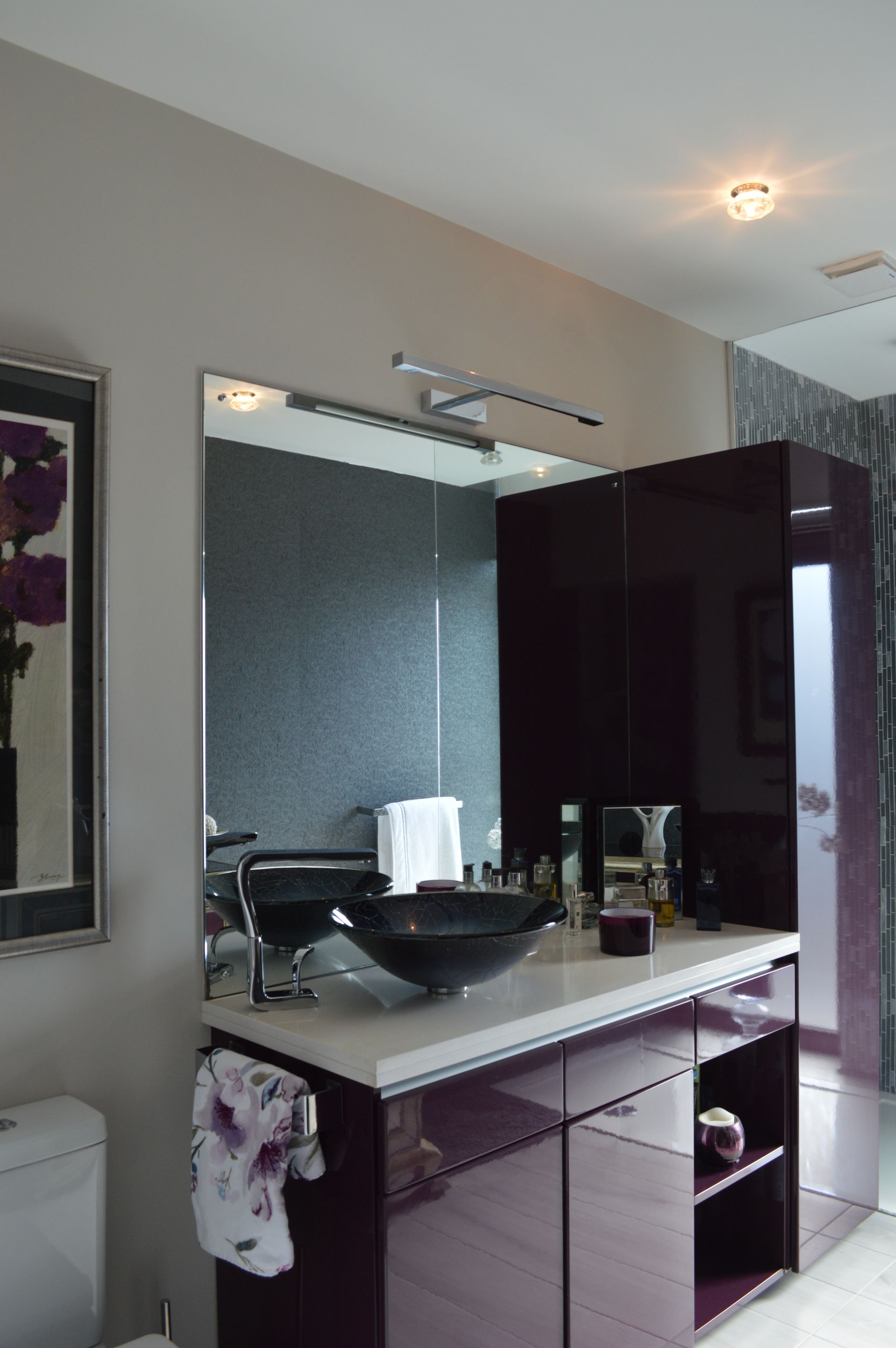 A bathroom with purple cabinets and a sink
