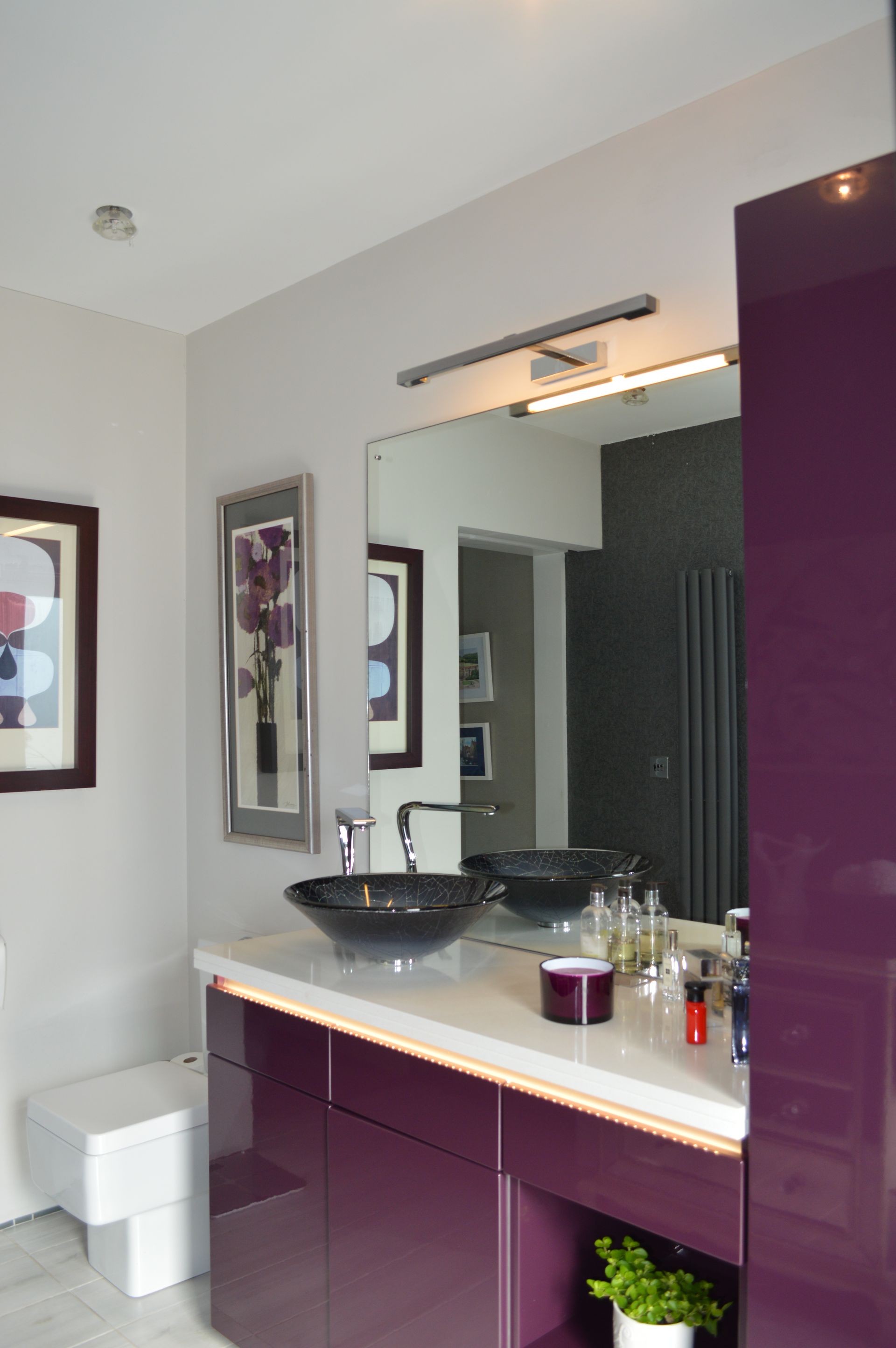 A bathroom with purple cabinets and a sink