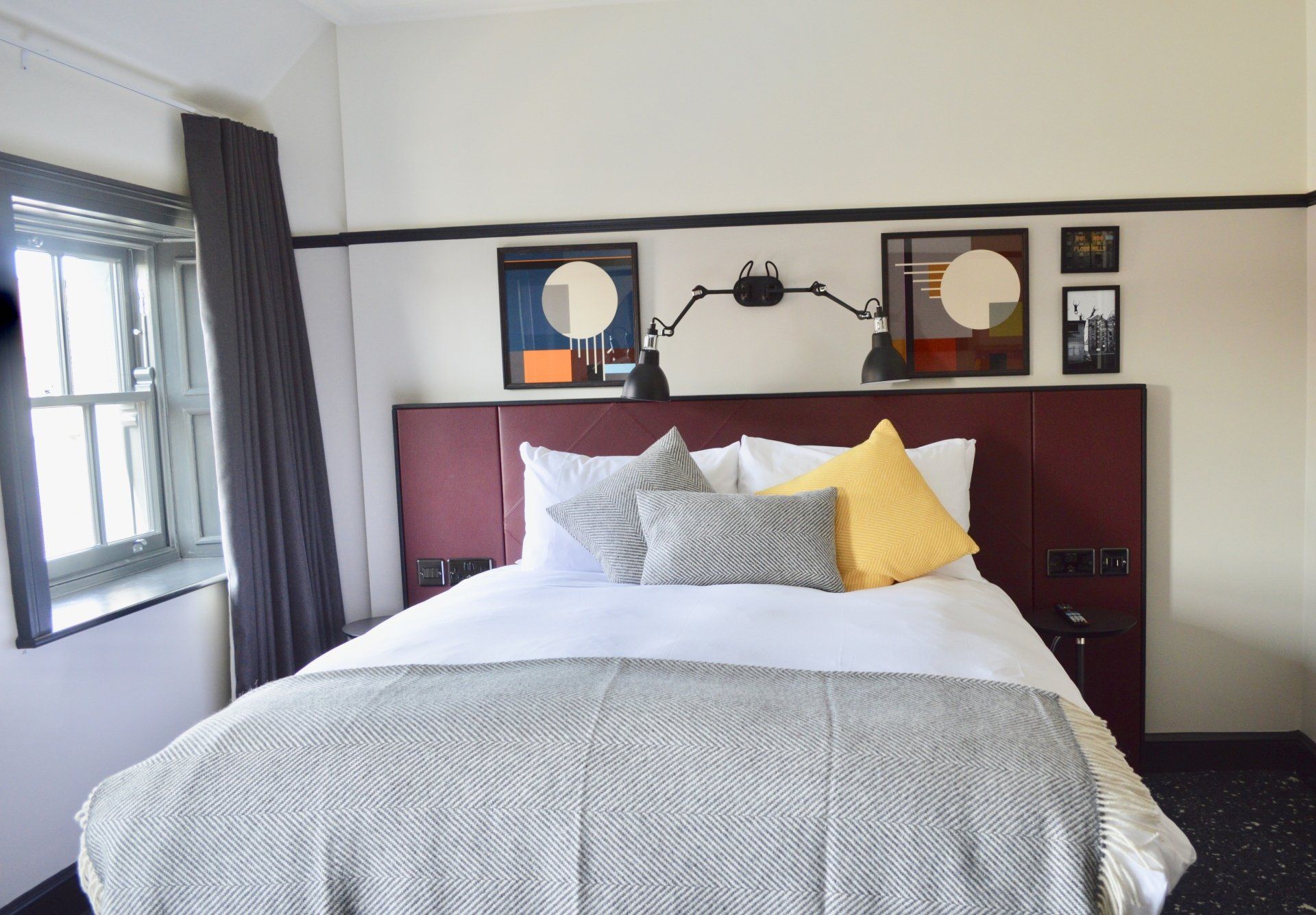 A hotel room with a bed and a window