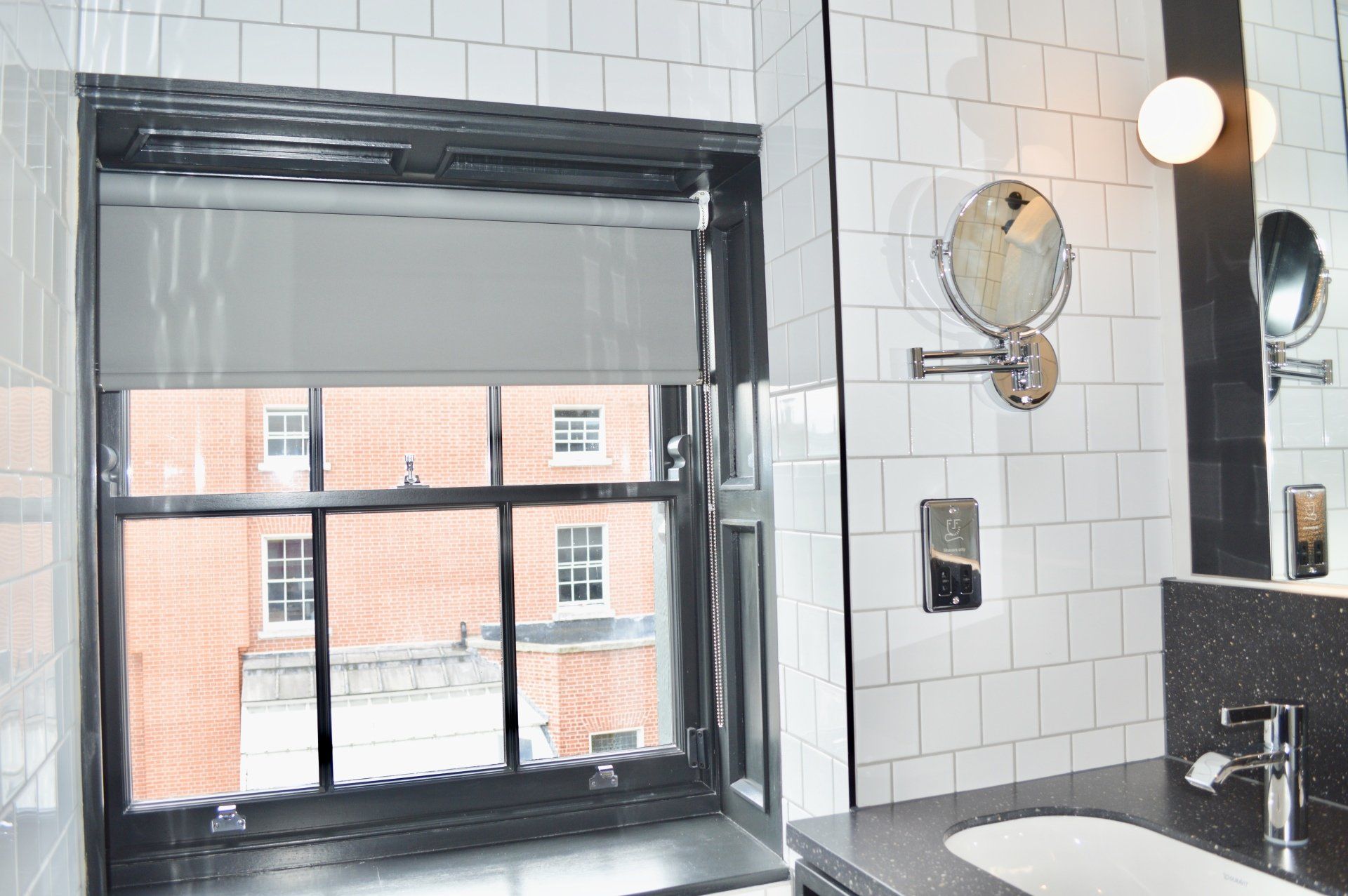 A bathroom with a sink a mirror and a window