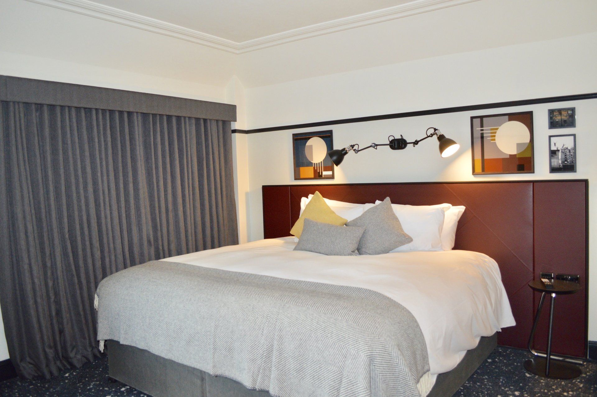 A hotel room with a king size bed and a table