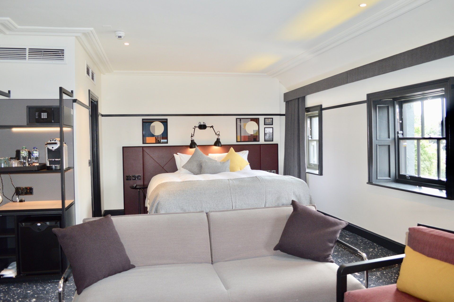 A hotel room with a couch and a bed