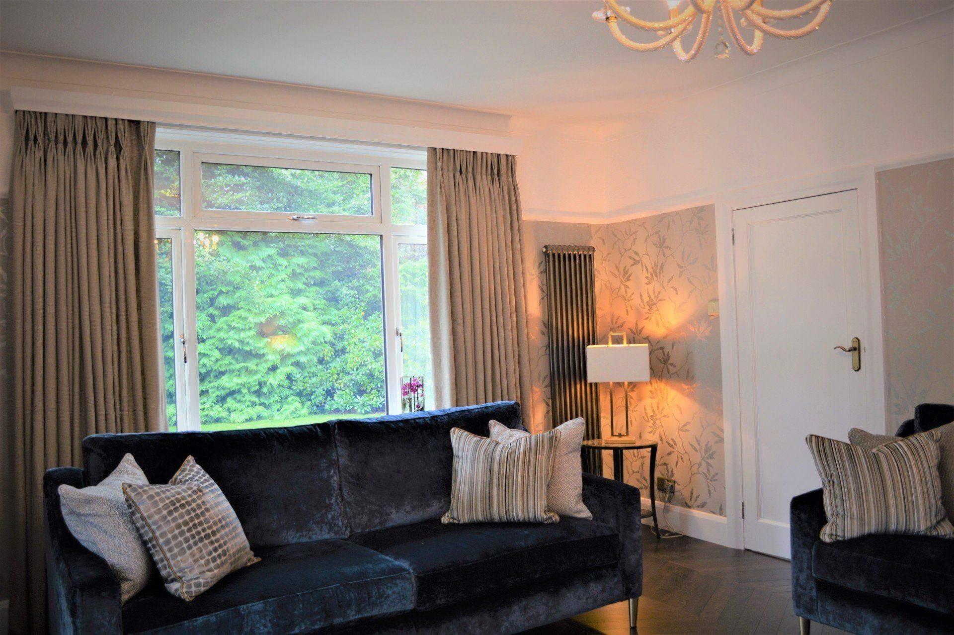 A living room with two couches and a large window.