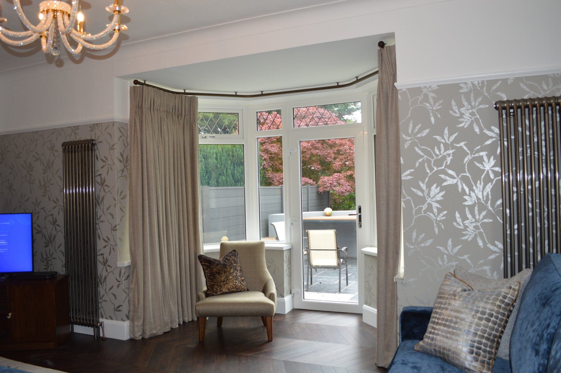 A living room with a couch , chair and television.