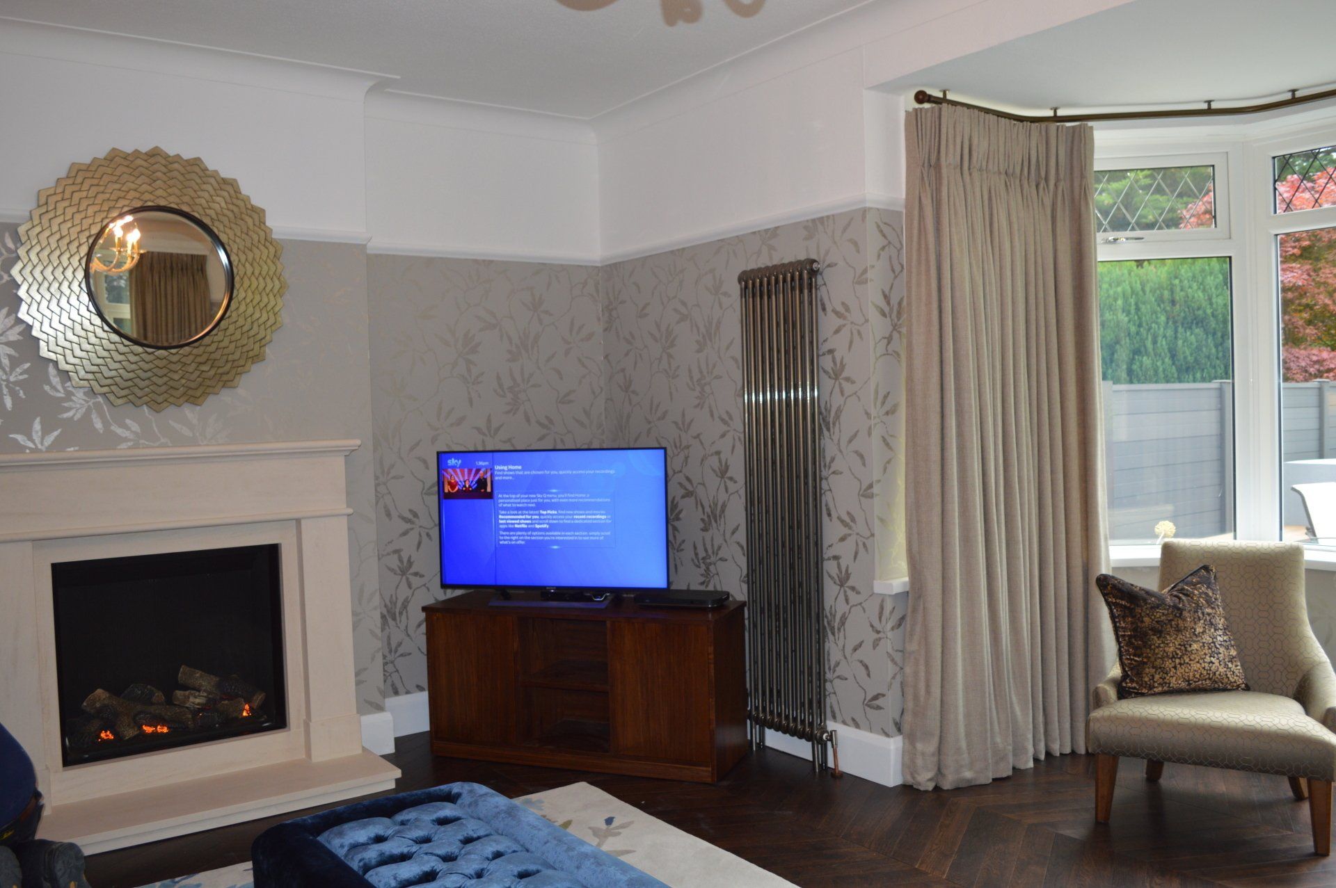 A living room with a fireplace and a flat screen tv
