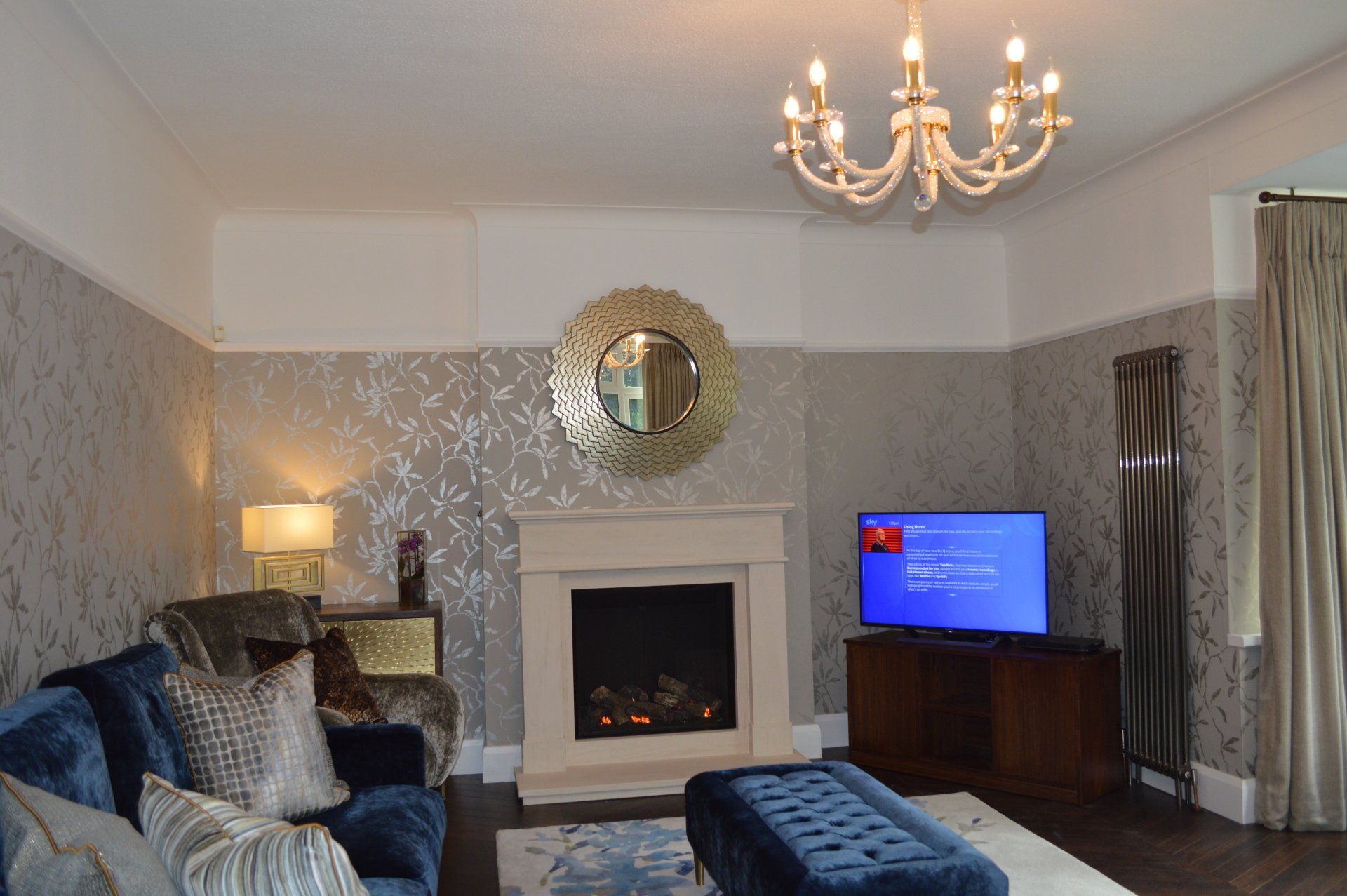 A living room with a fireplace and a flat screen tv