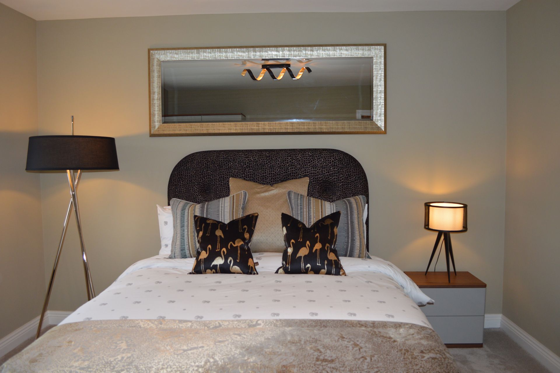 There is a large mirror above the bed in the bedroom.
