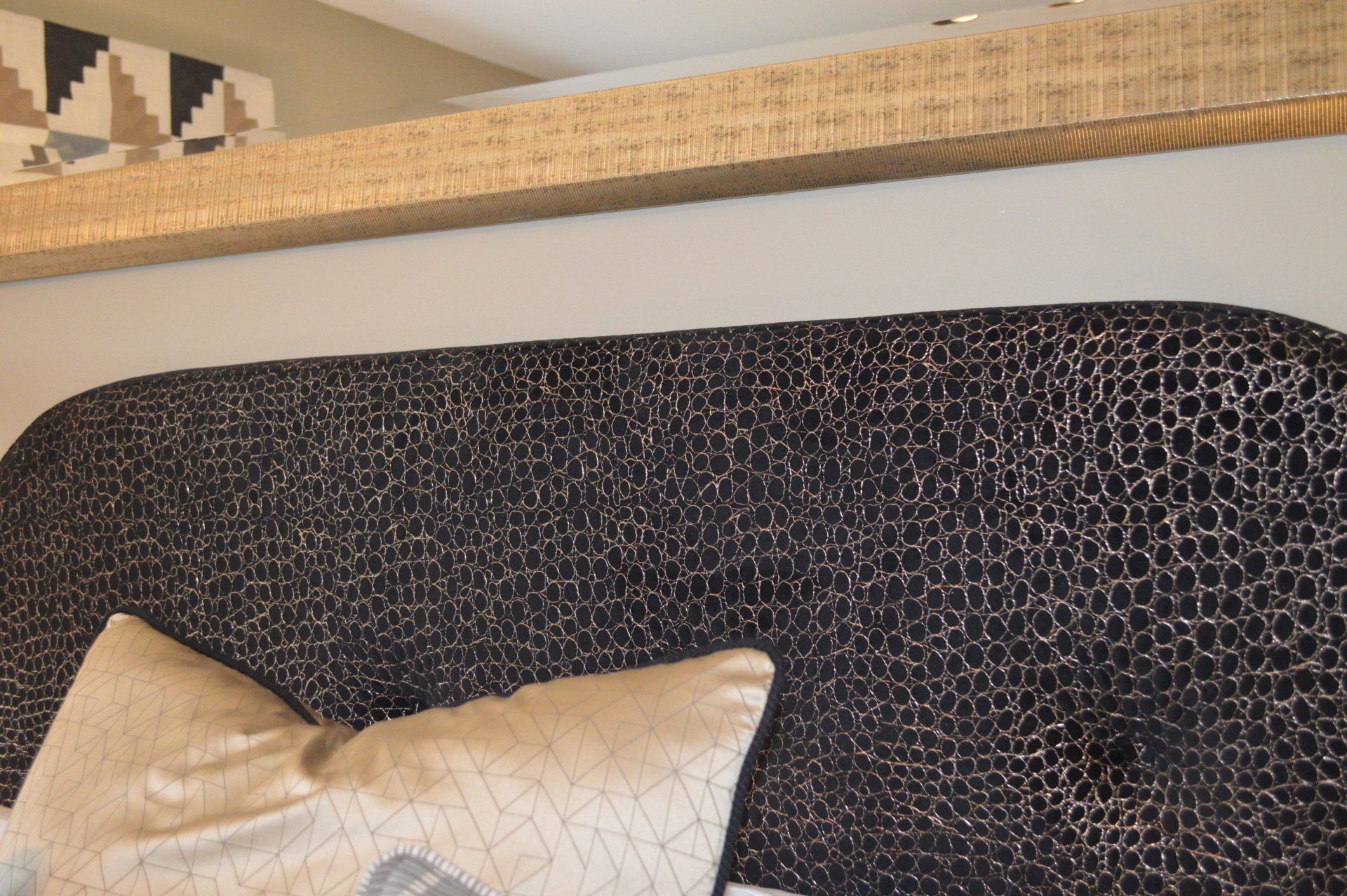 A close up of a couch with a pillow on it.