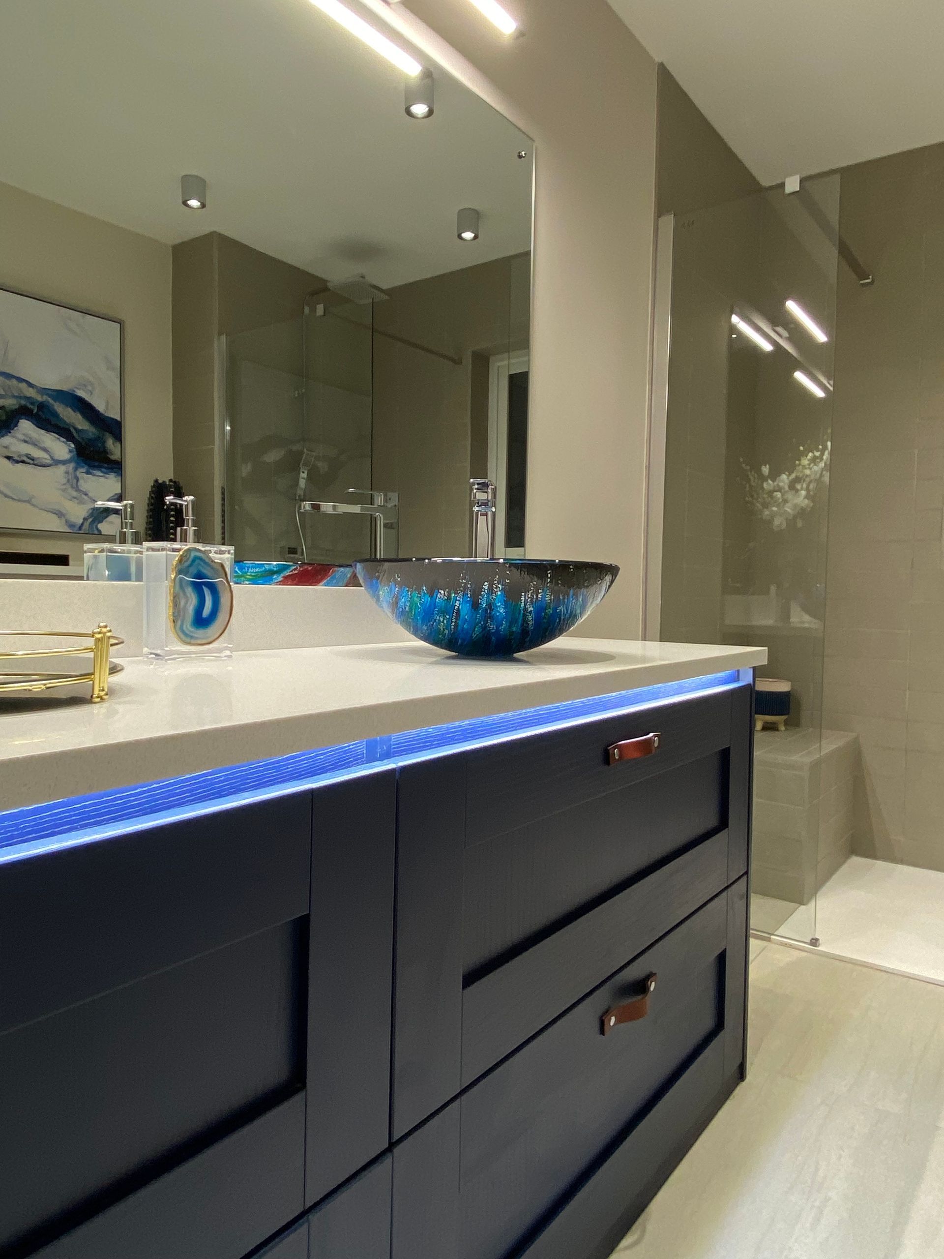 A bathroom with a sink and a large mirror