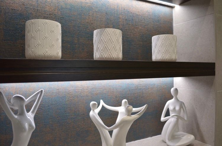 A shelf with a bunch of statues on it