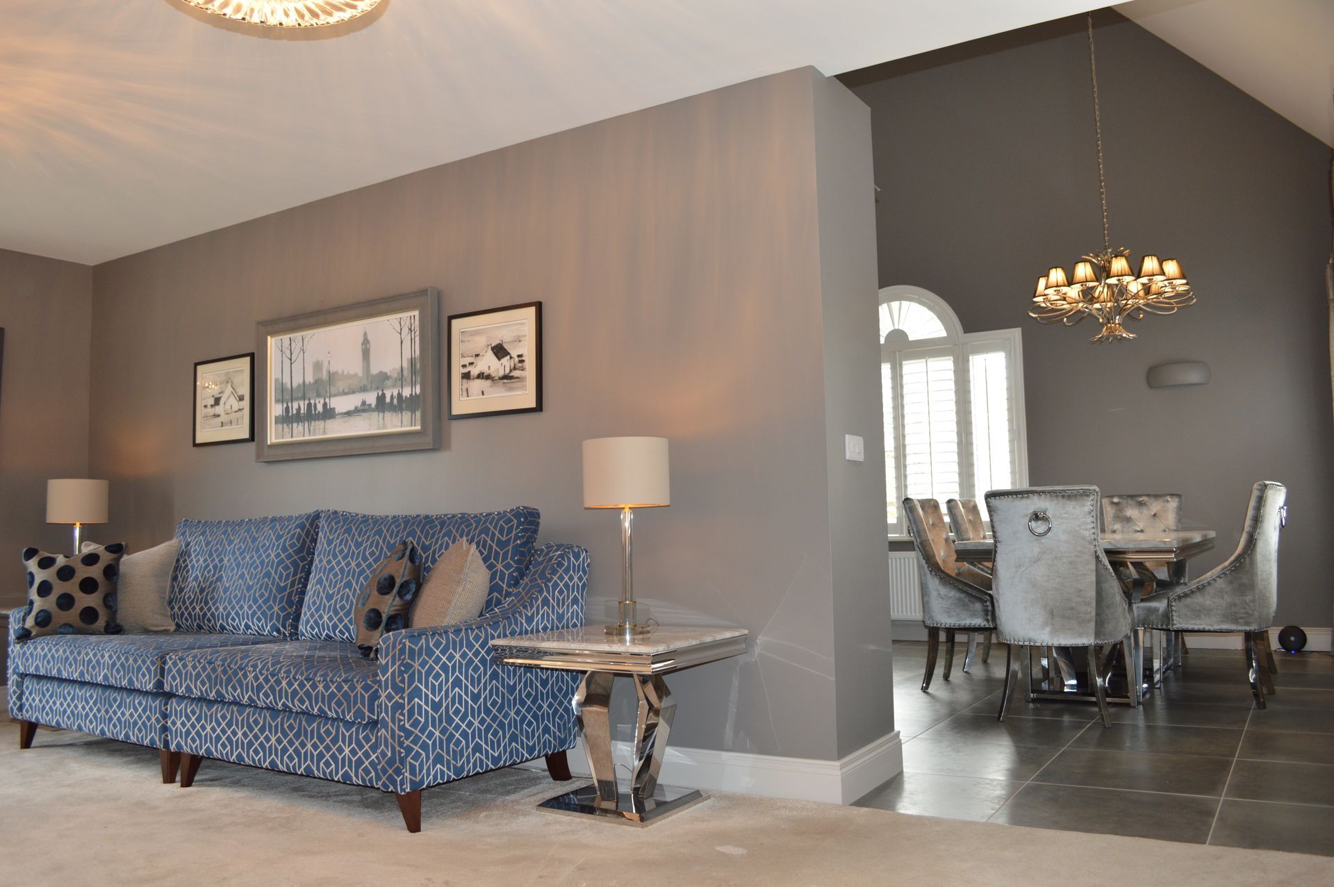 A living room with a blue couch and a table