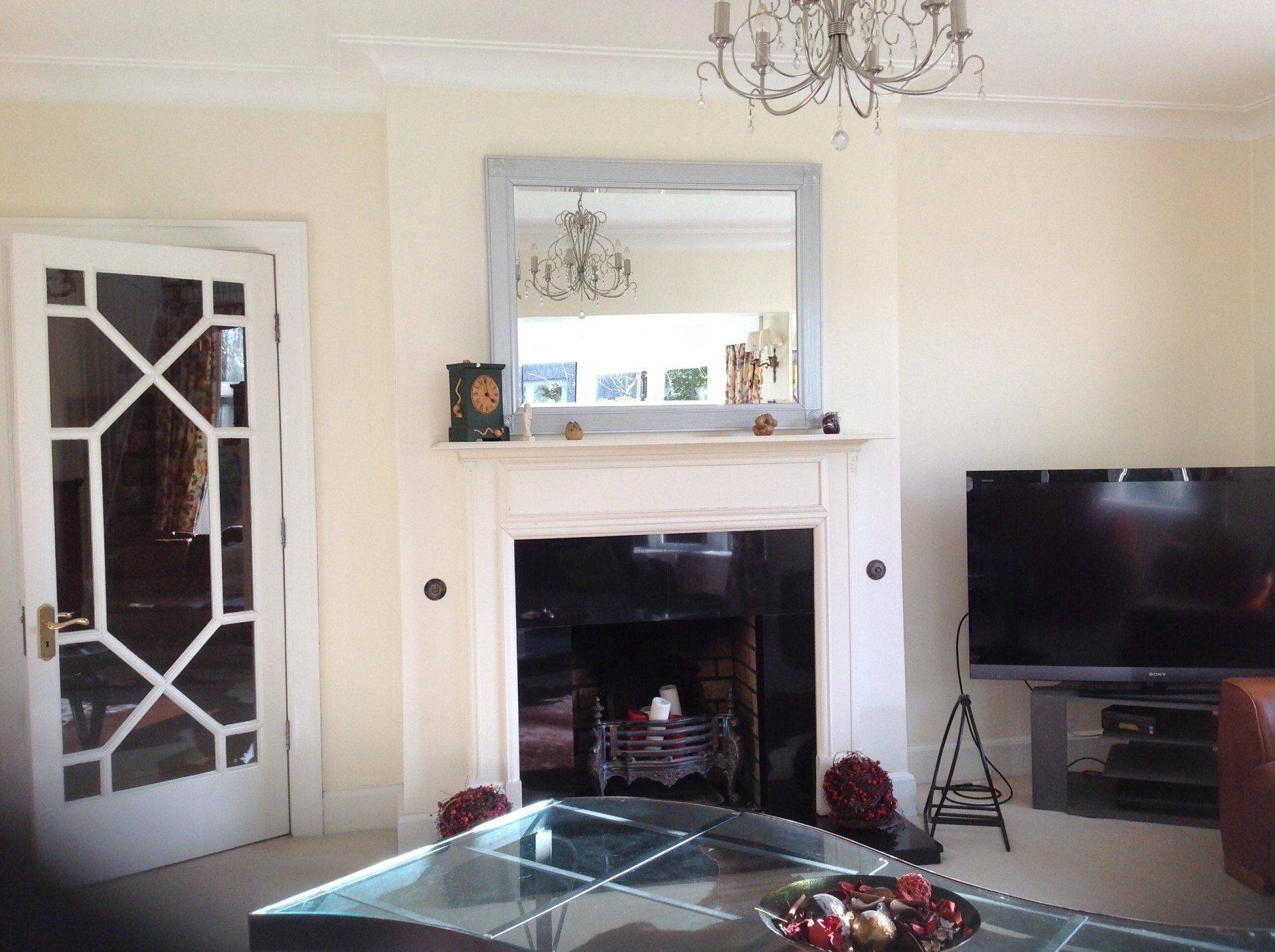 A living room with a fireplace and a flat screen tv