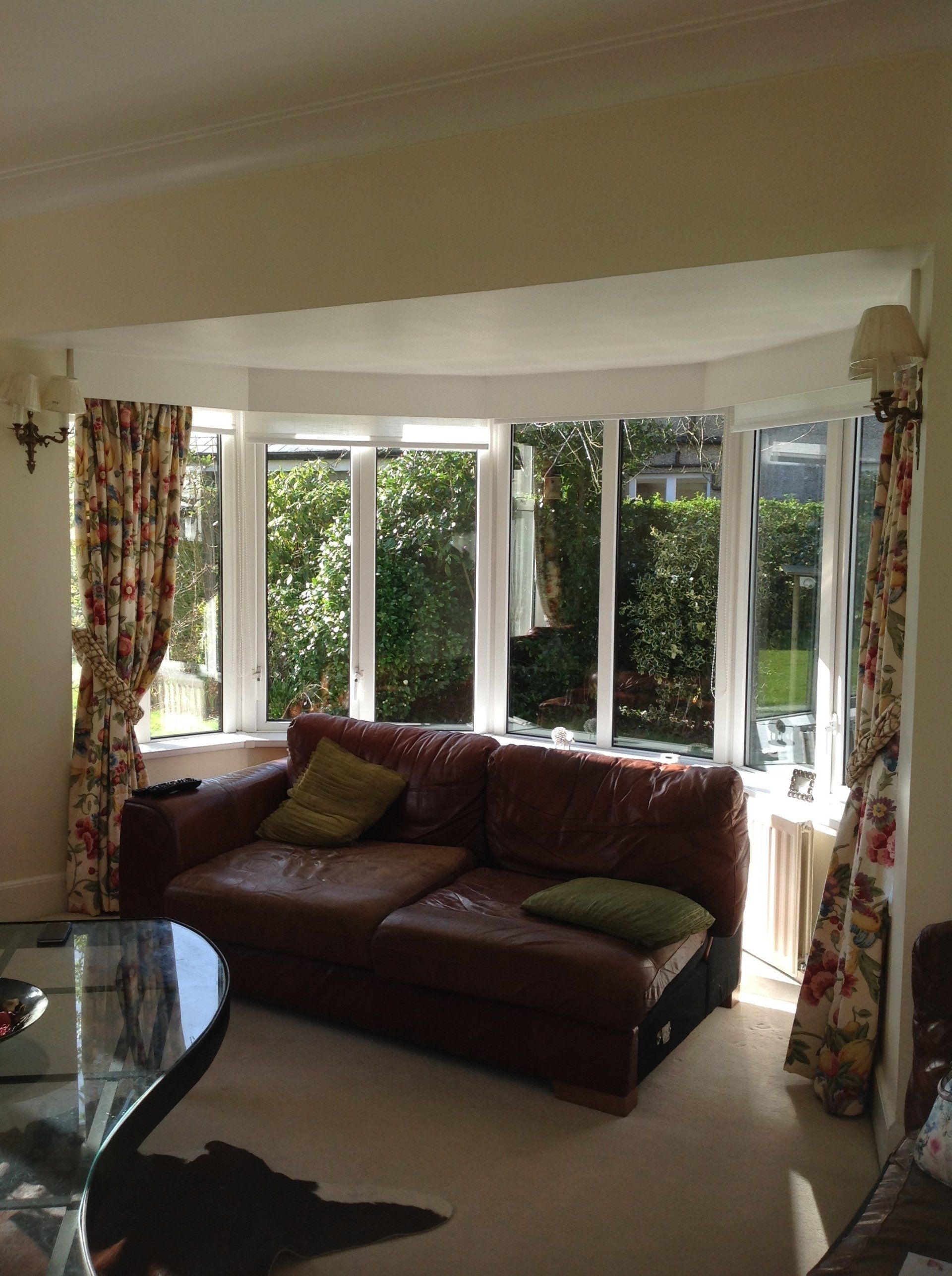 A living room with a brown couch and a table