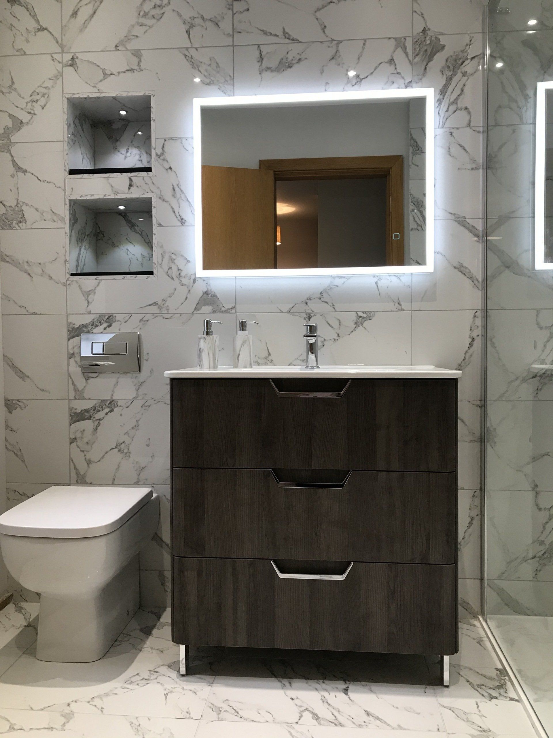 A bathroom with a sink , toilet and mirror