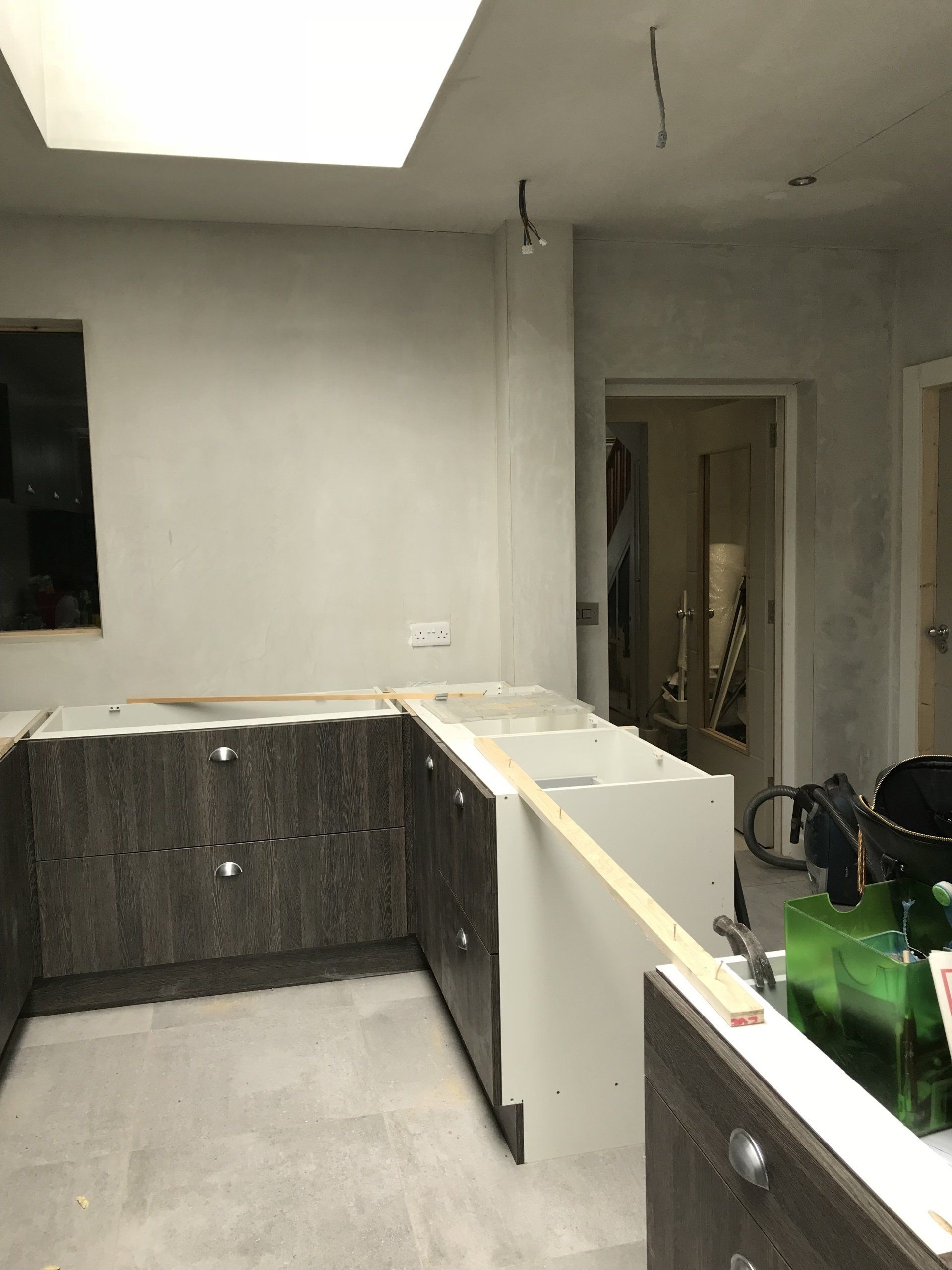 A kitchen under construction with a lot of cabinets and a sink.