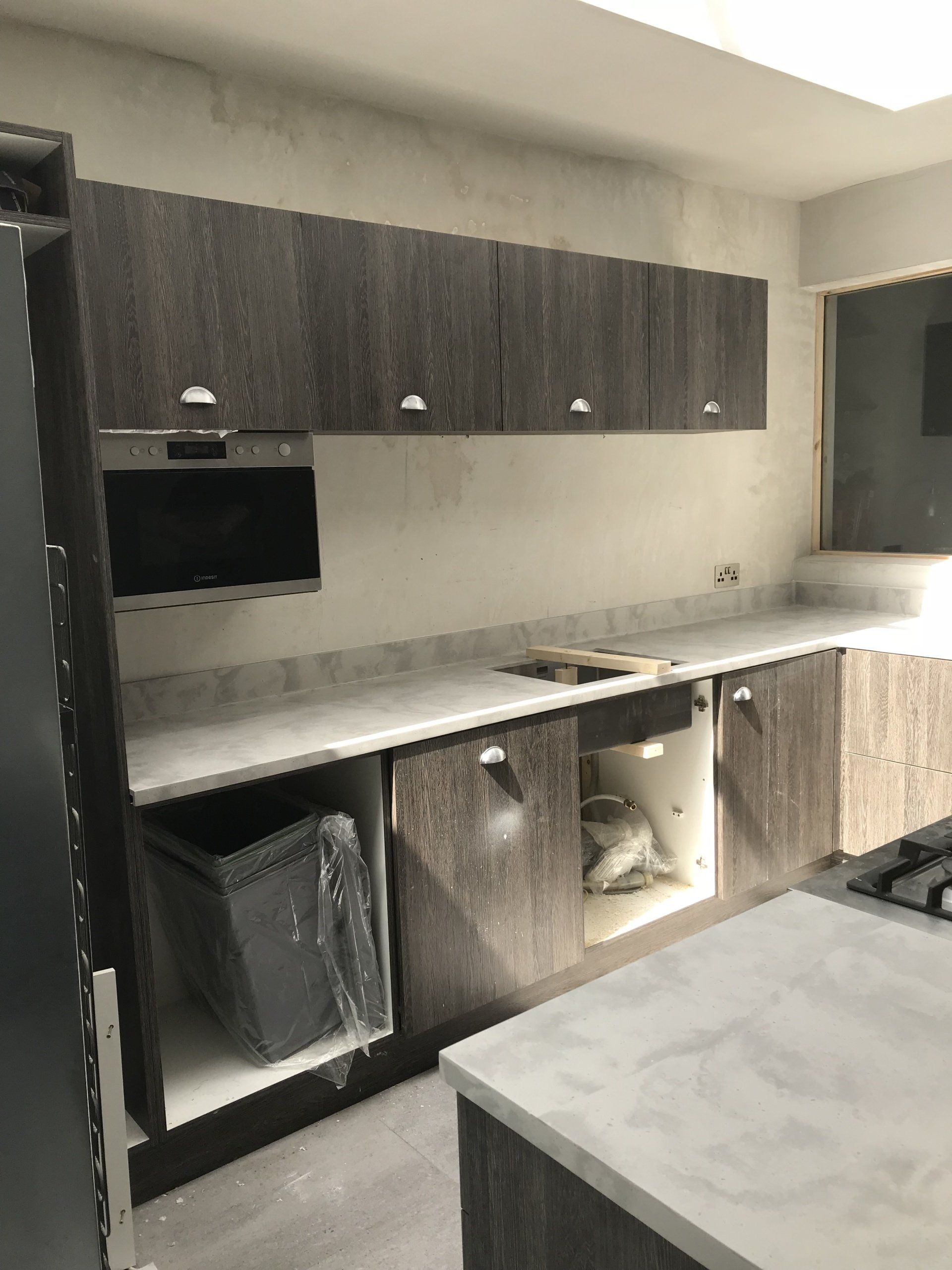 A kitchen with a lot of cabinets and a stove top oven.