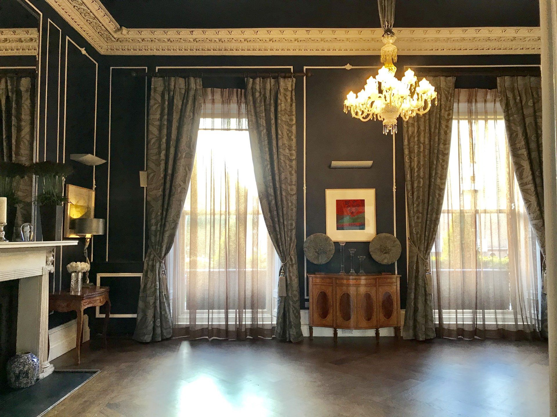 A living room with a fireplace and a chandelier