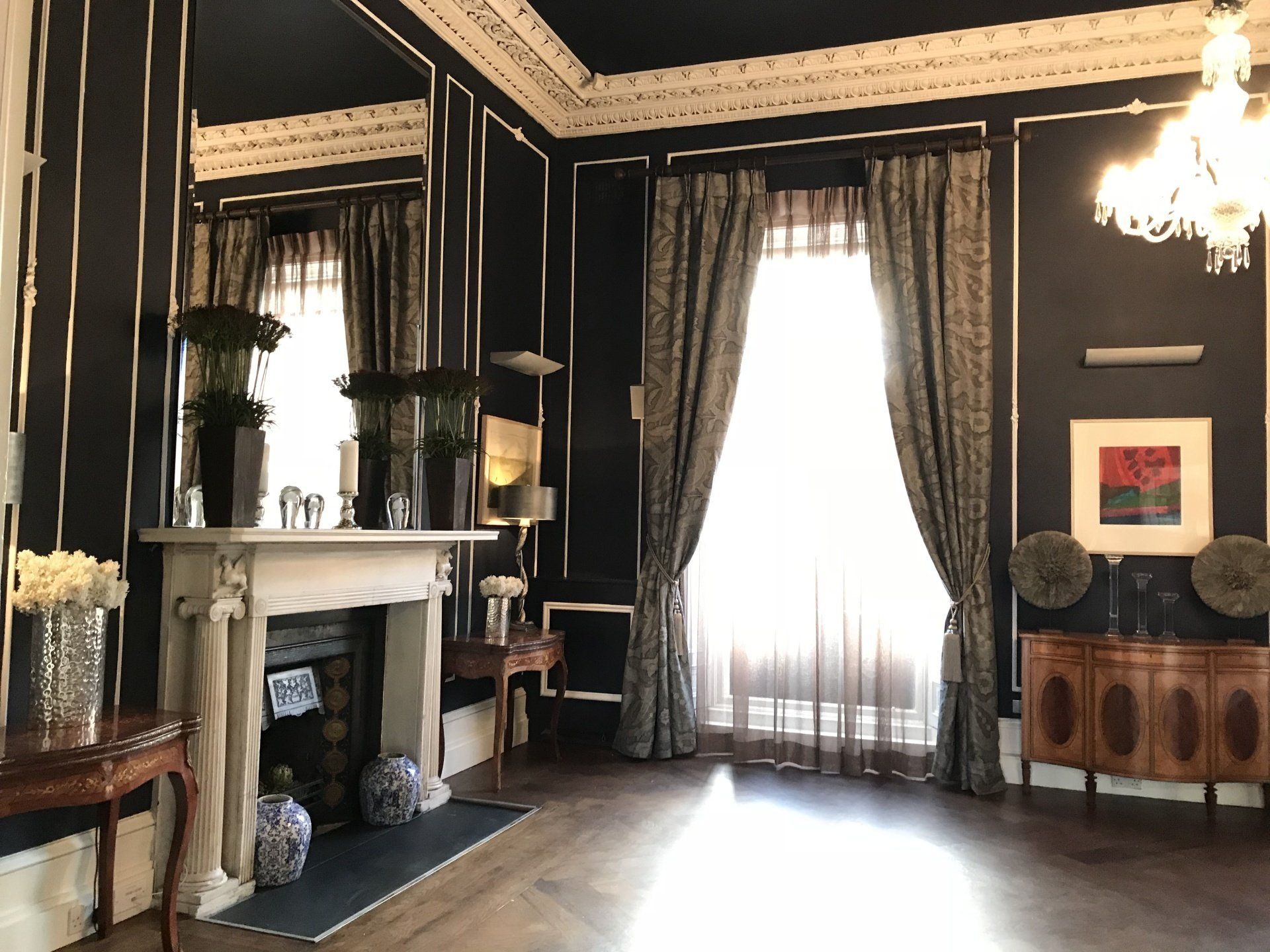 A living room with a fireplace and lots of windows