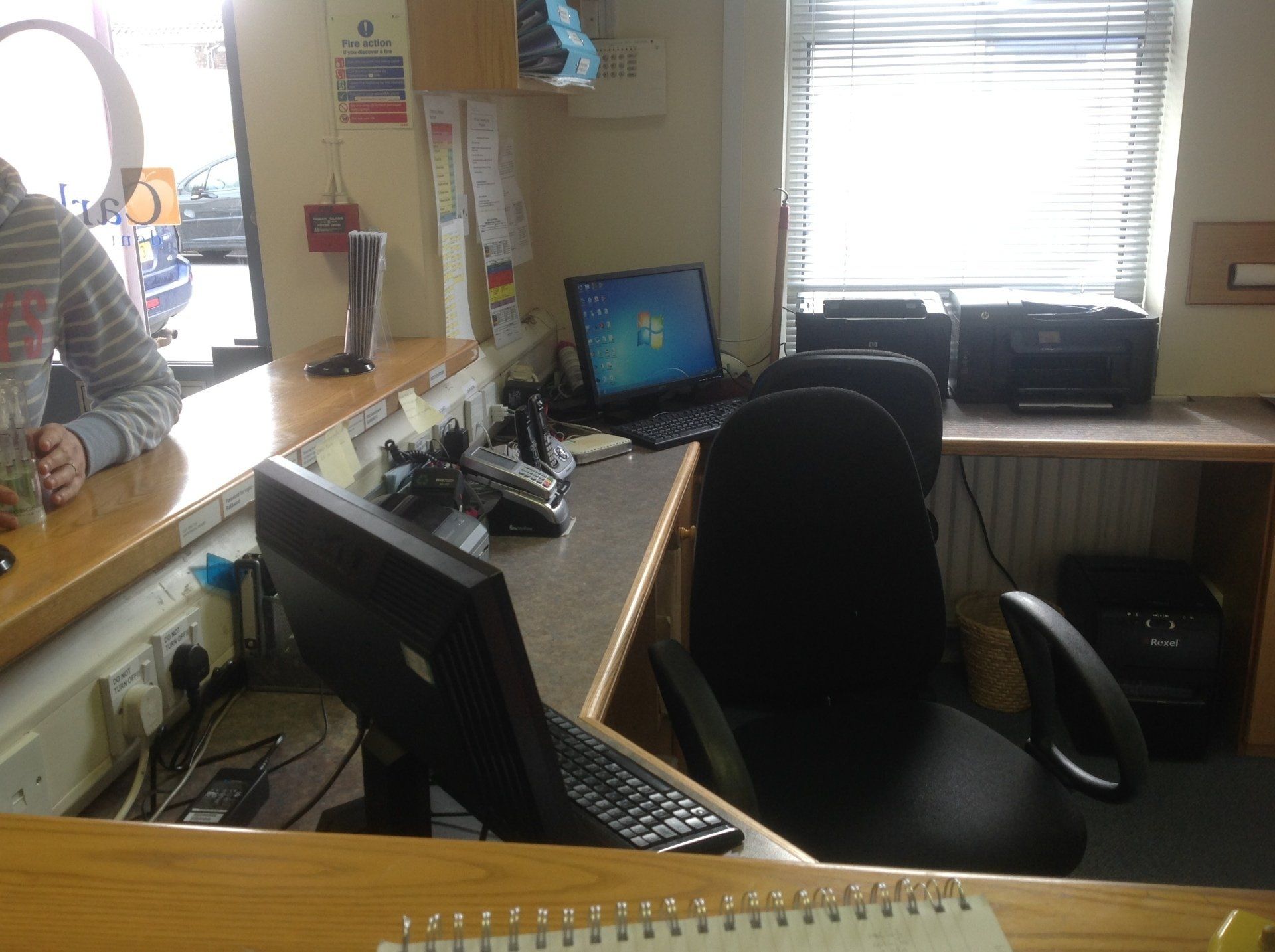 A desk with a computer and a printer on it