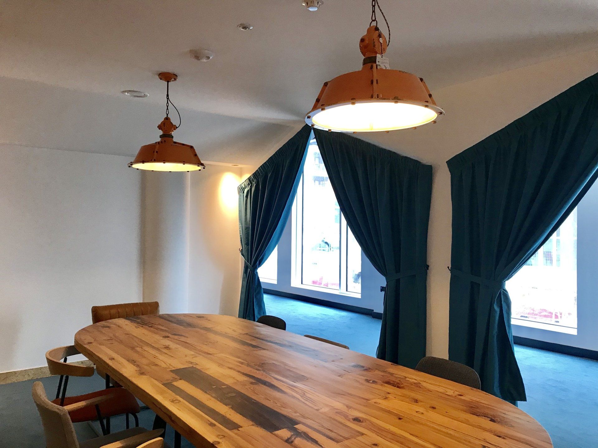 There is a long wooden table in the middle of the room.