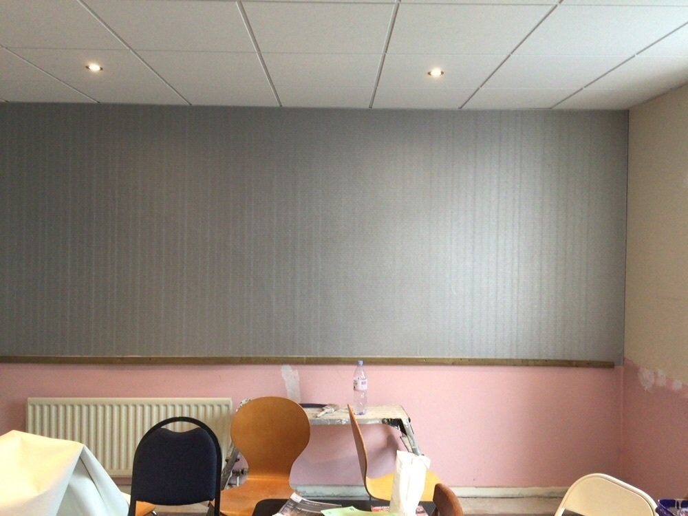 A room with chairs and a laptop on a table