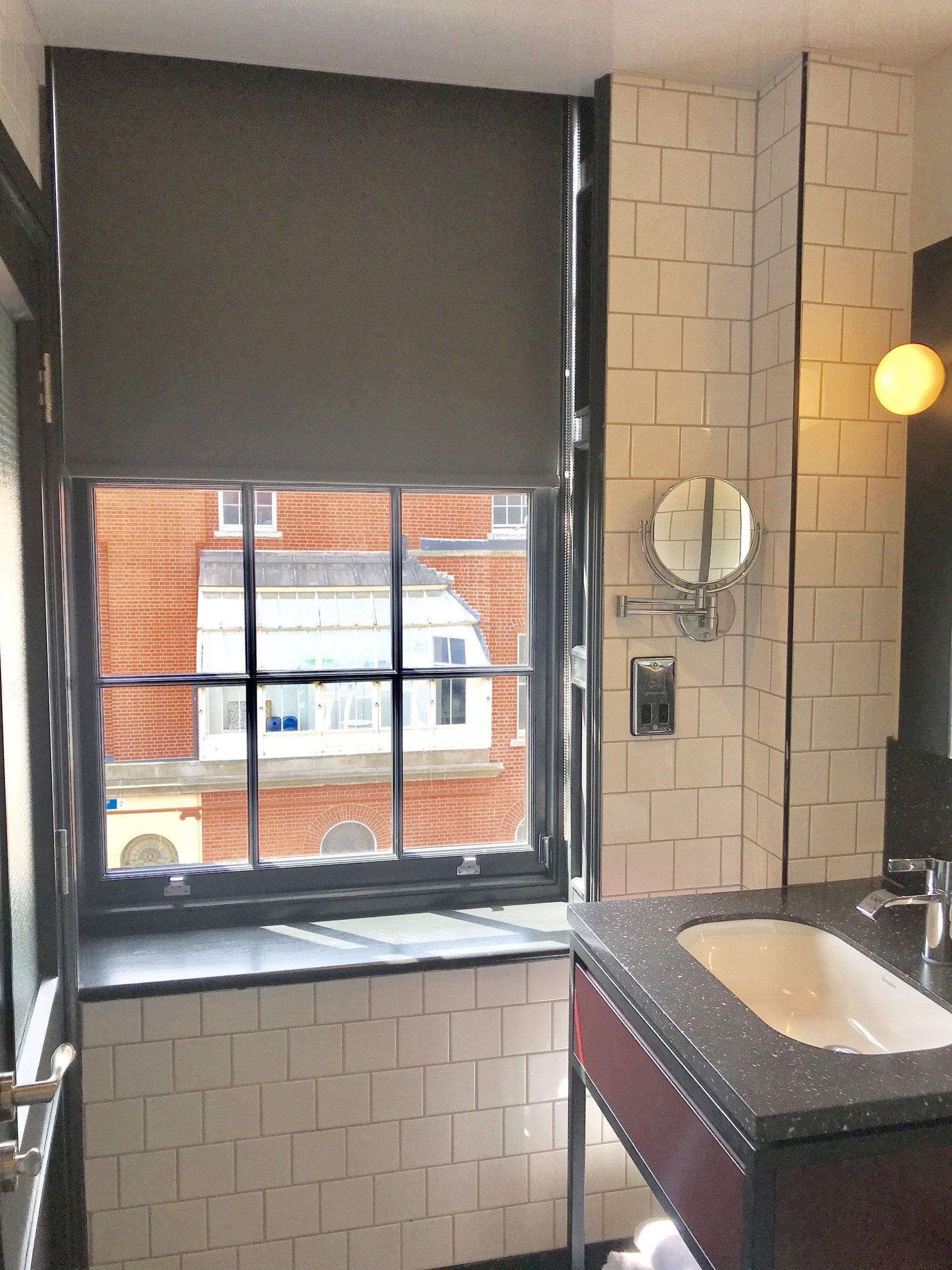 A bathroom with a sink a mirror and a window