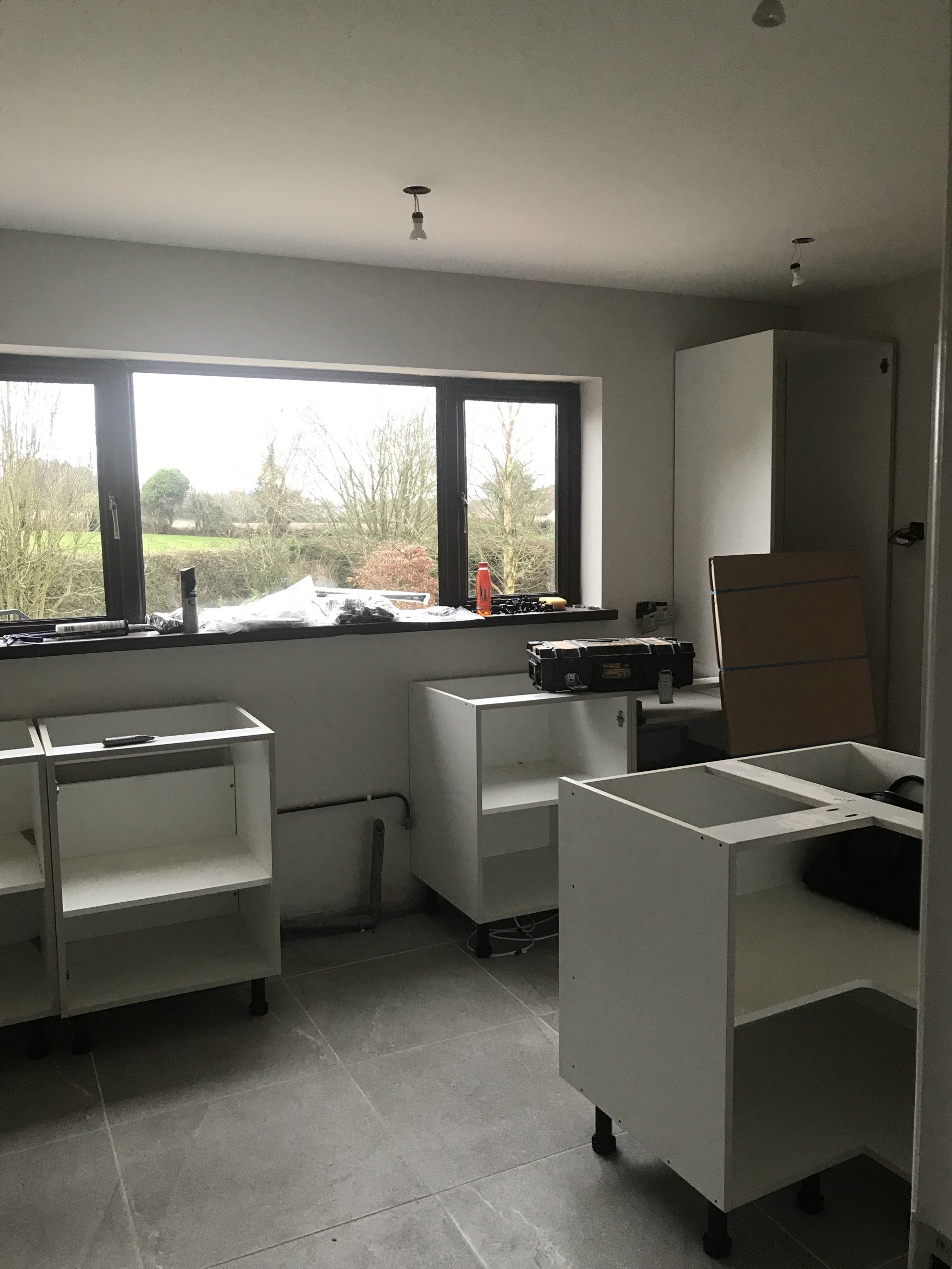 A room with a lot of cabinets and a window