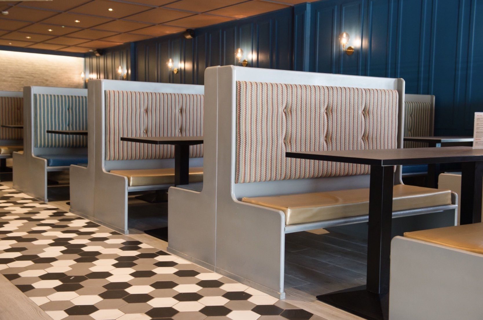 A row of booths with tables in a restaurant.