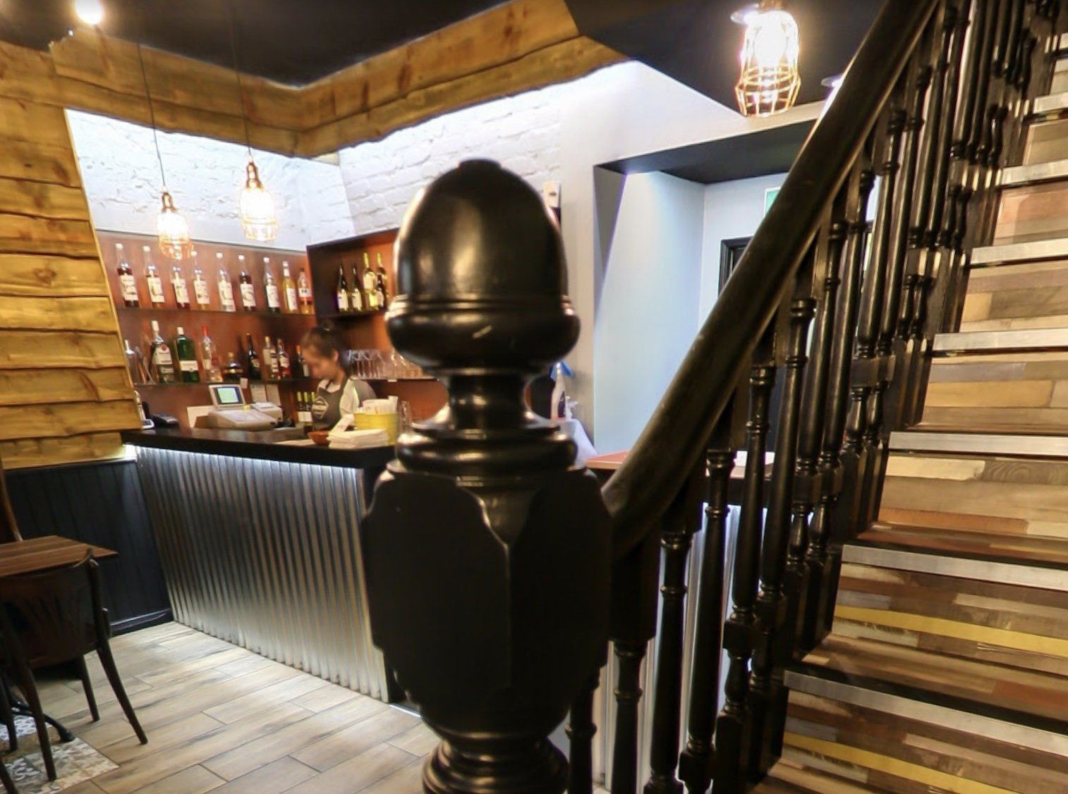 A staircase leading up to a bar in a restaurant.