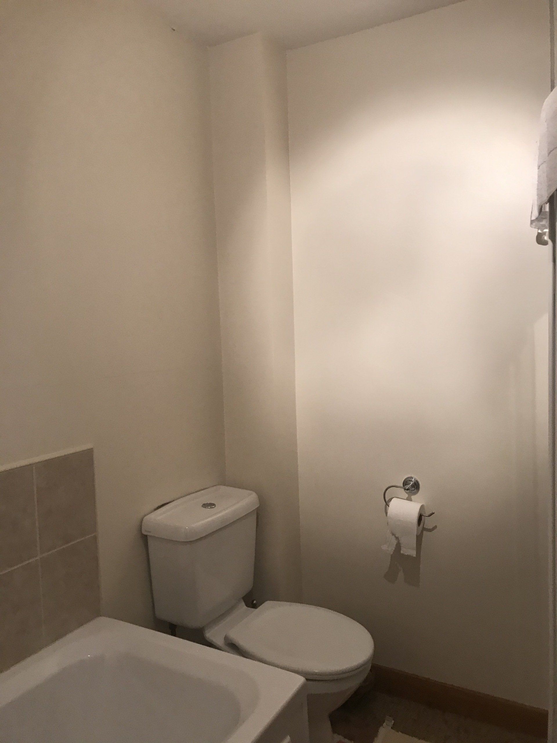 A bathroom with a toilet and a bathtub