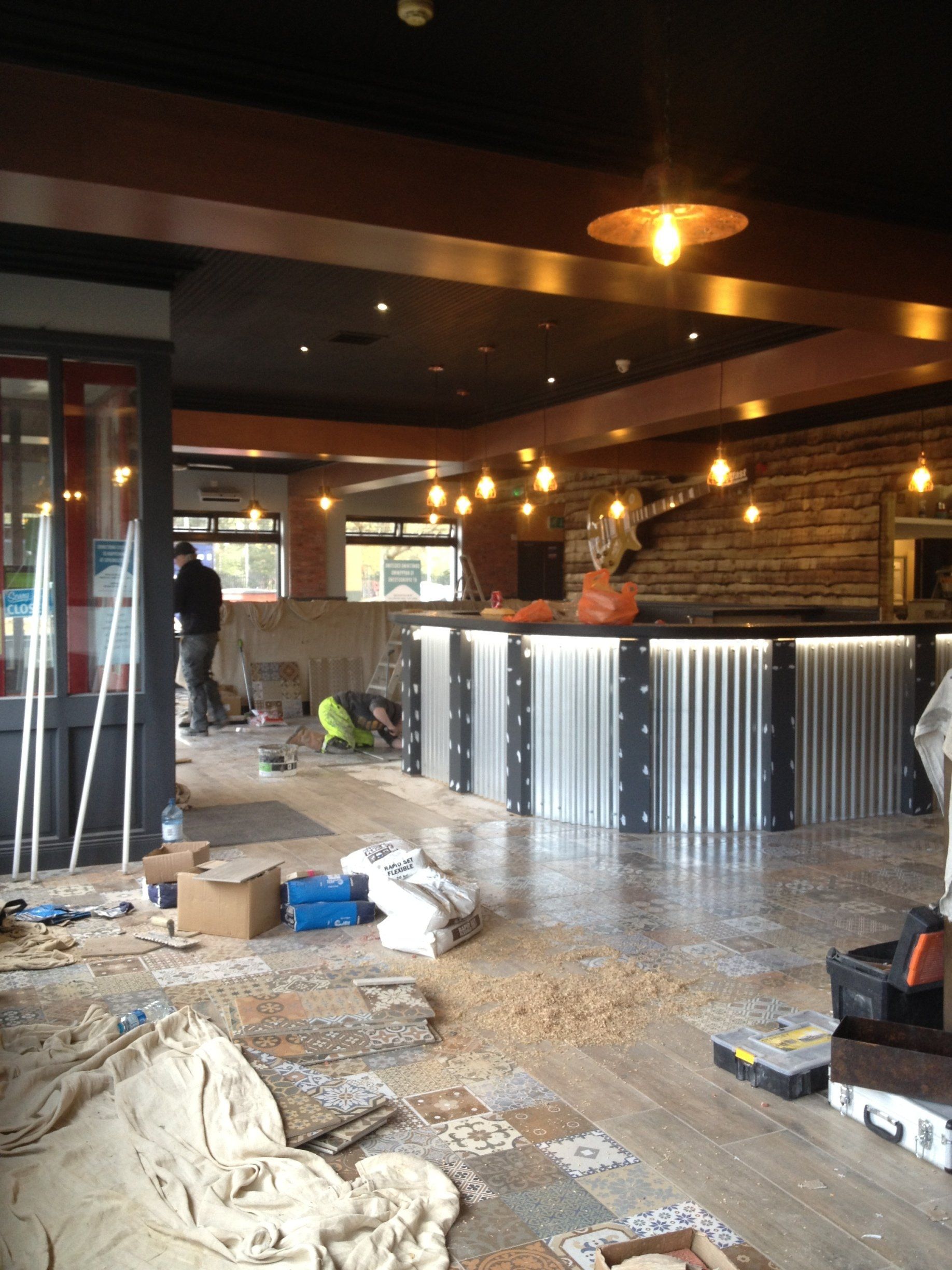 A room that is being remodeled with people working on it