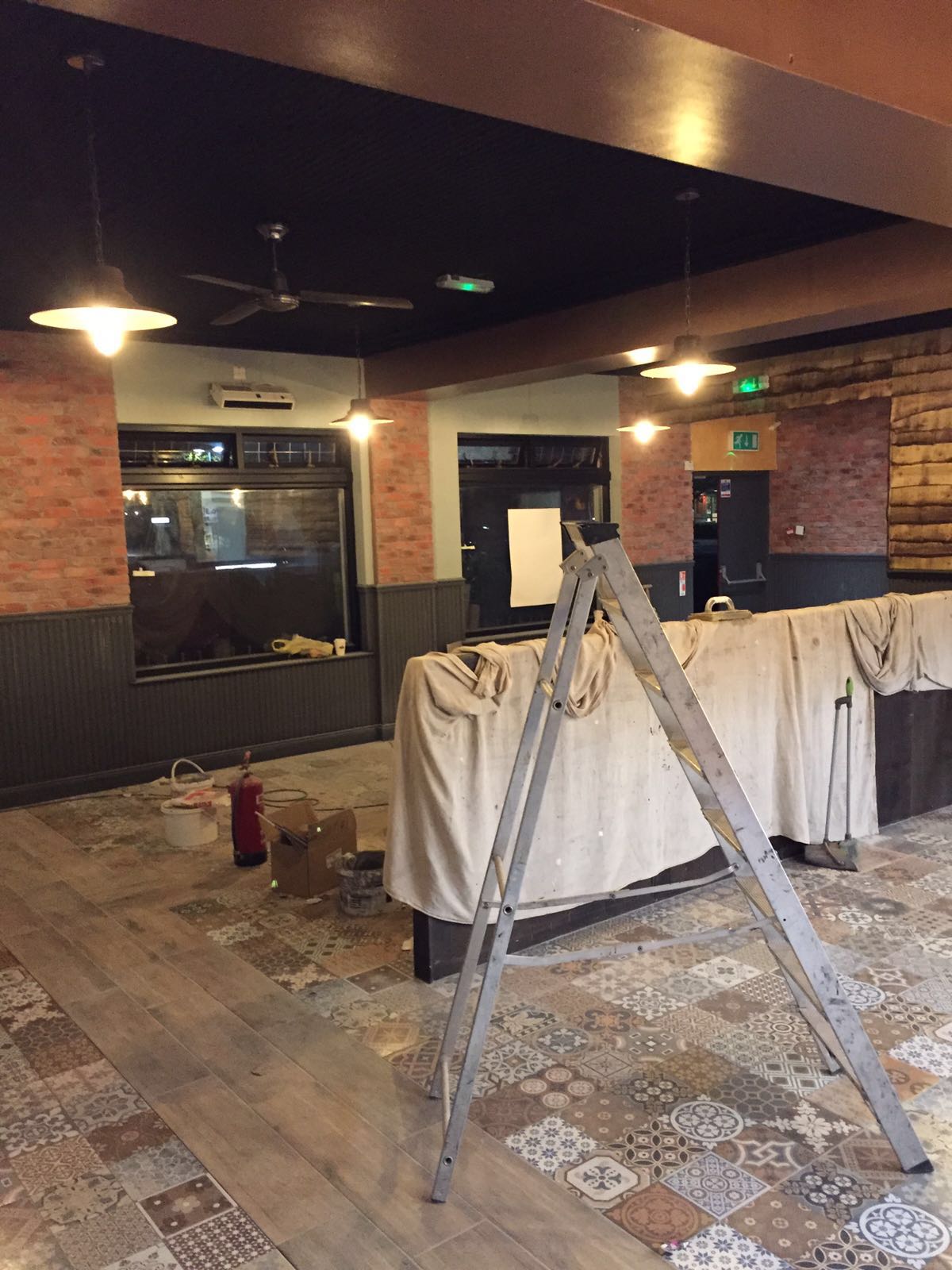 A ladder is sitting in the middle of a room.