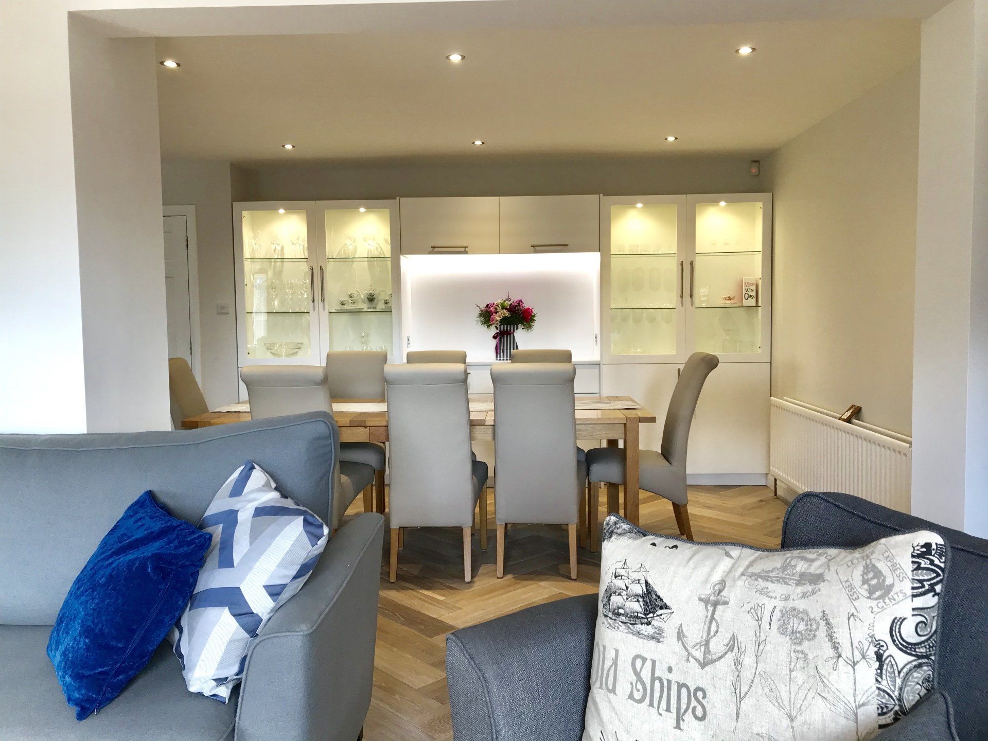 A living room with a couch , chair , table and chairs.