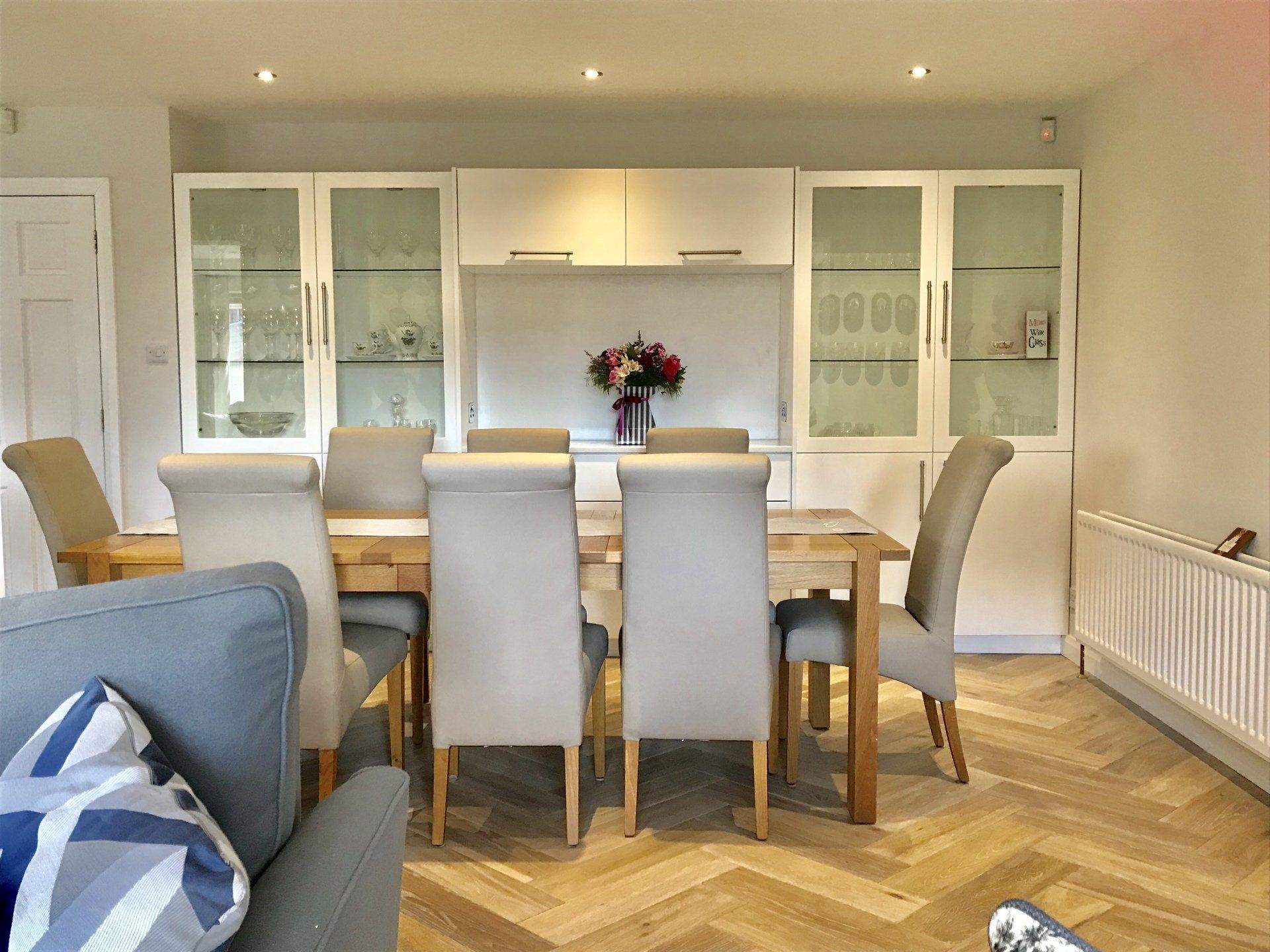 A living room with a dining room table and chairs