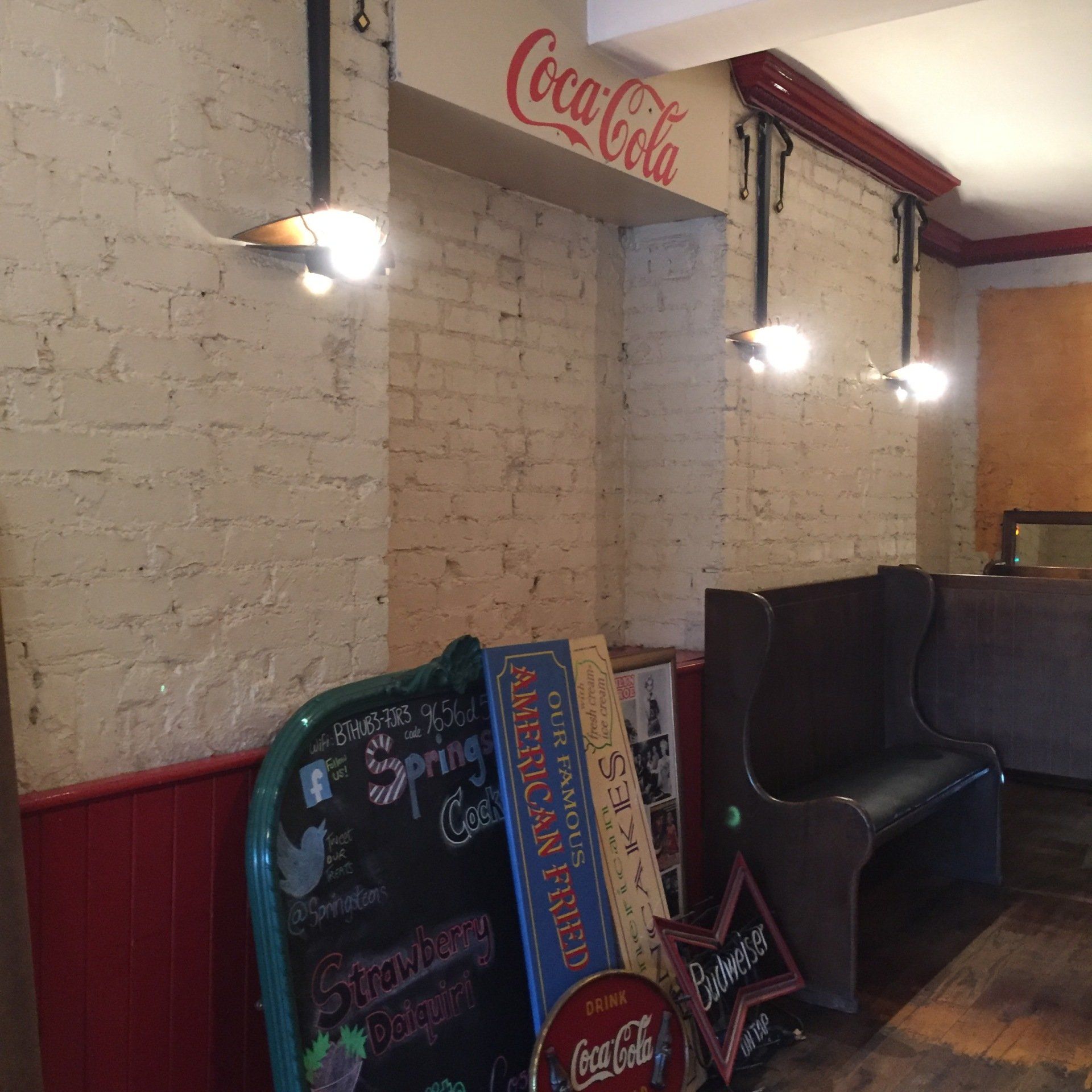 A room with a coca cola sign on the wall