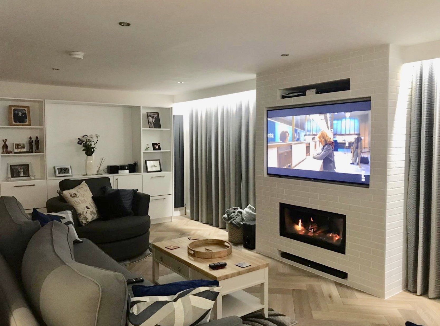 A living room with a fireplace and a flat screen tv.