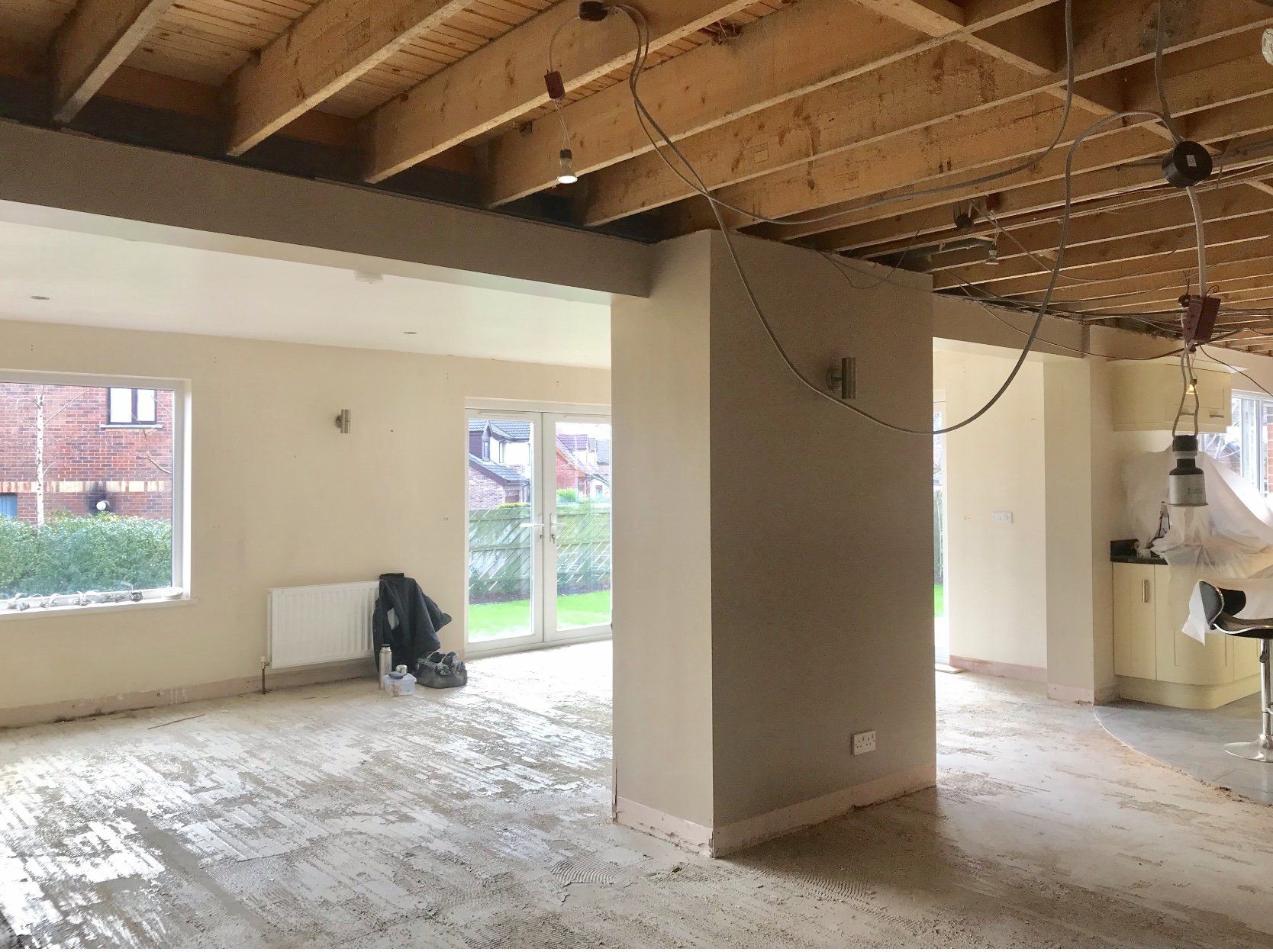 An empty room with a wooden ceiling and a lot of windows