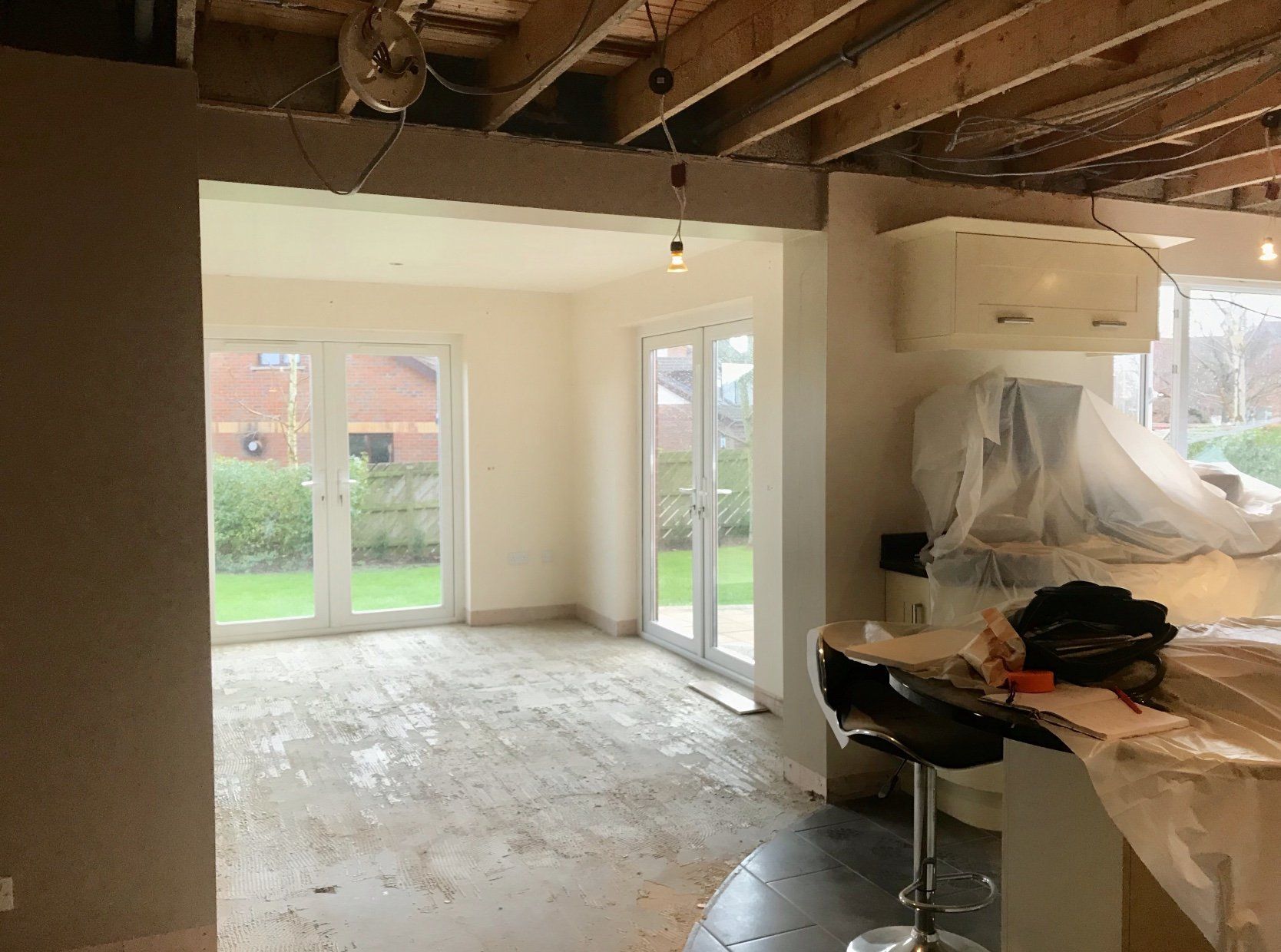 An empty room with a lot of windows and stools.