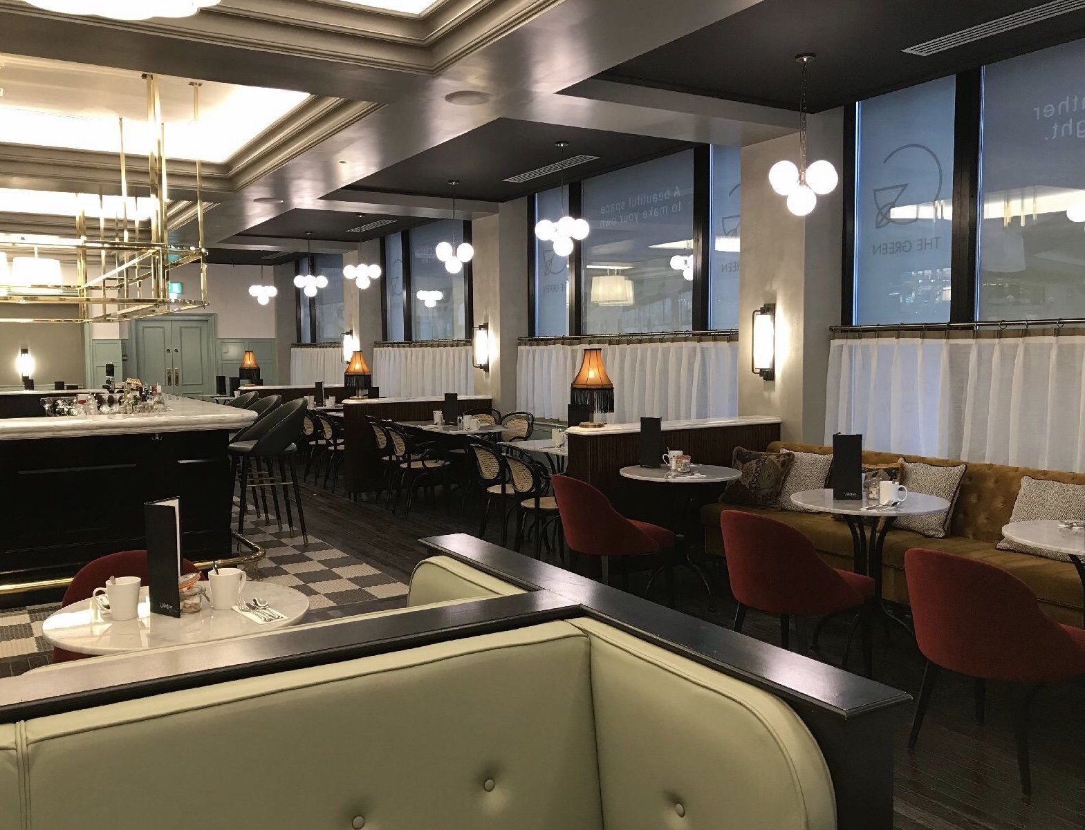 A large dining room with tables and chairs in a restaurant.