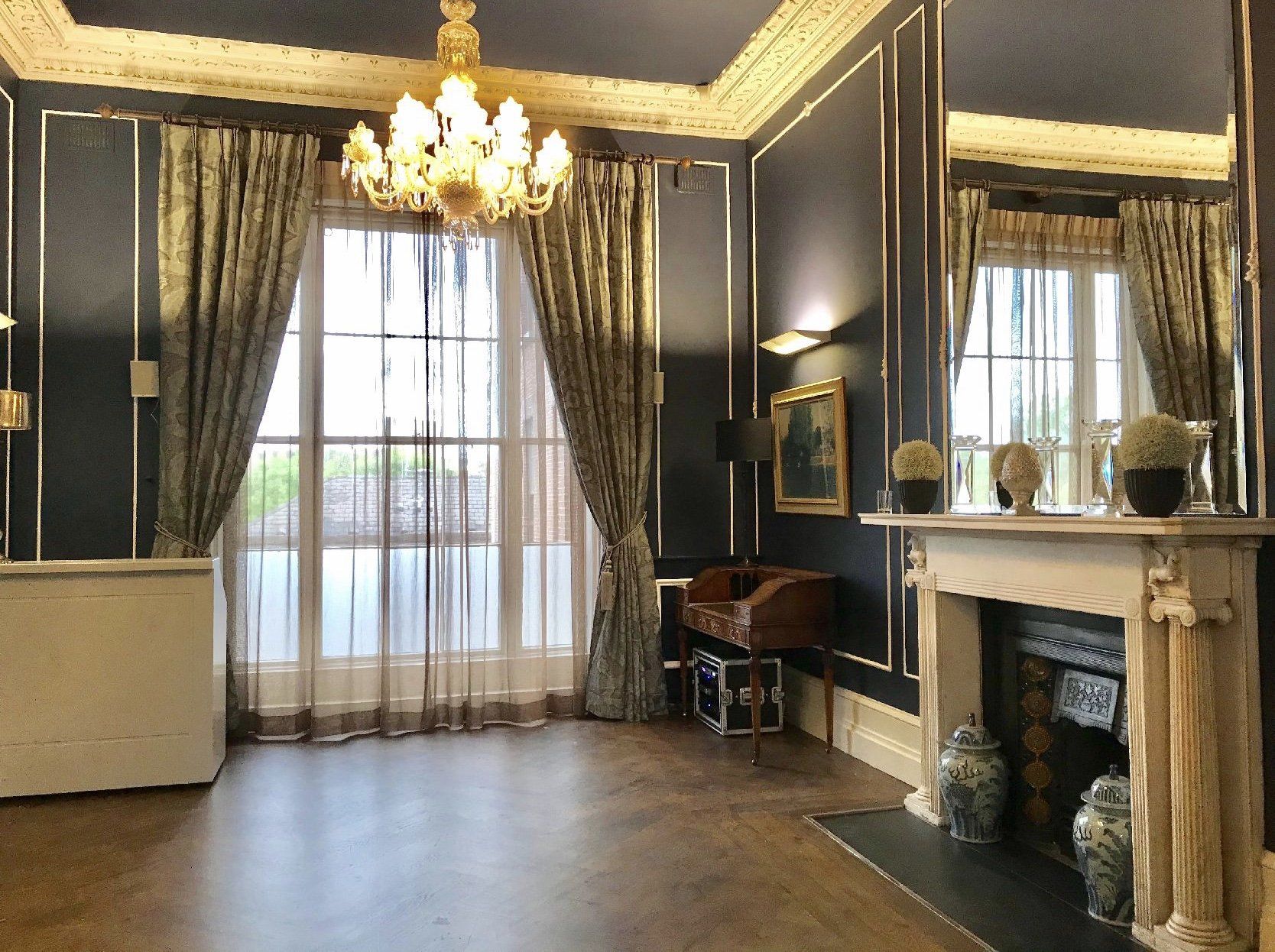 A living room with a fireplace and a chandelier