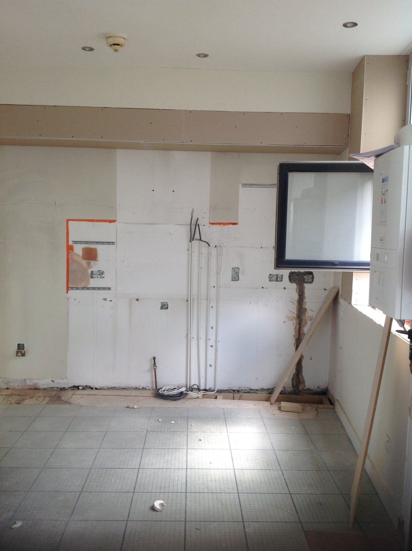 An empty room with tile floors and white walls