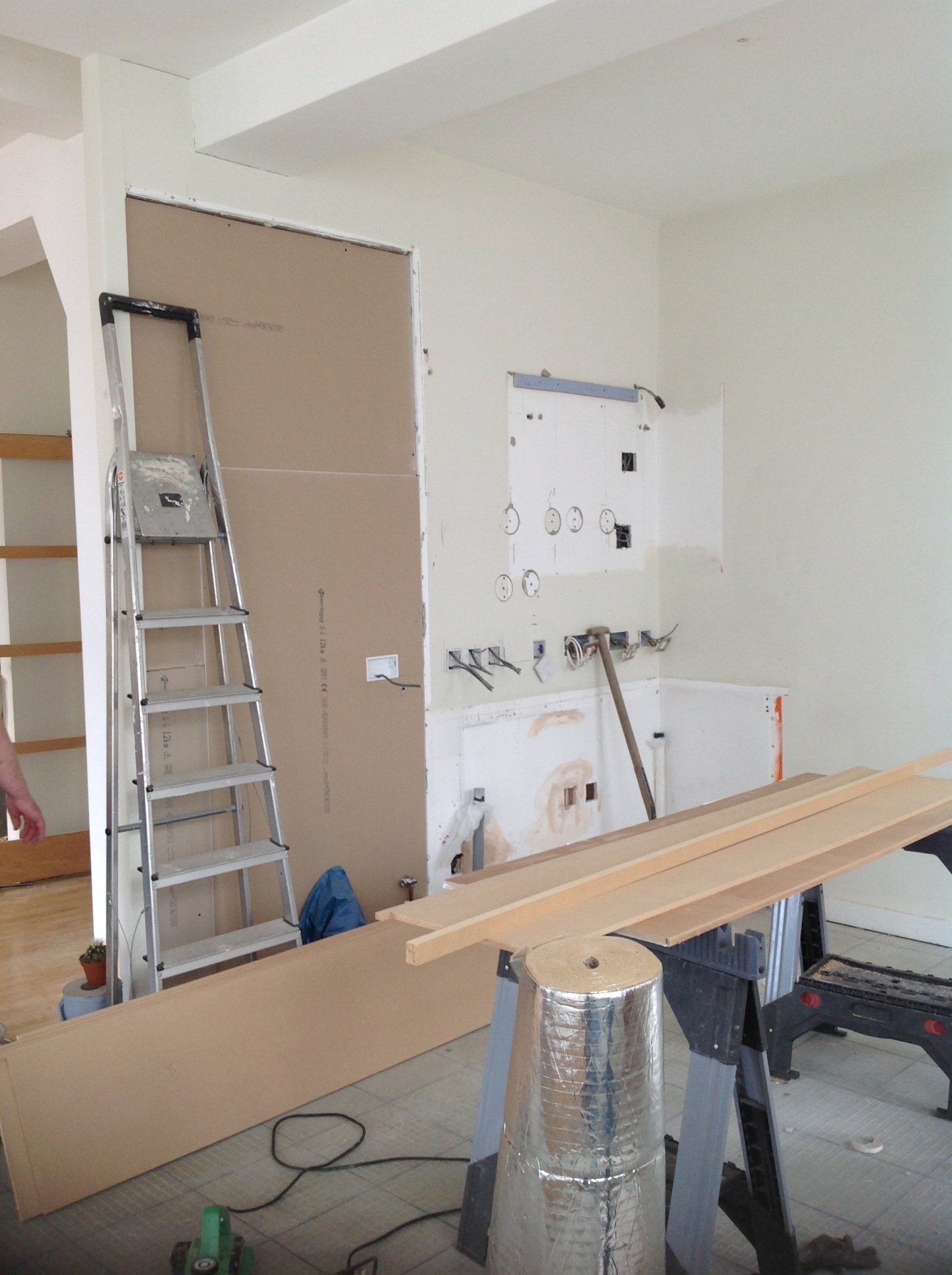 A room with a ladder and a piece of wood