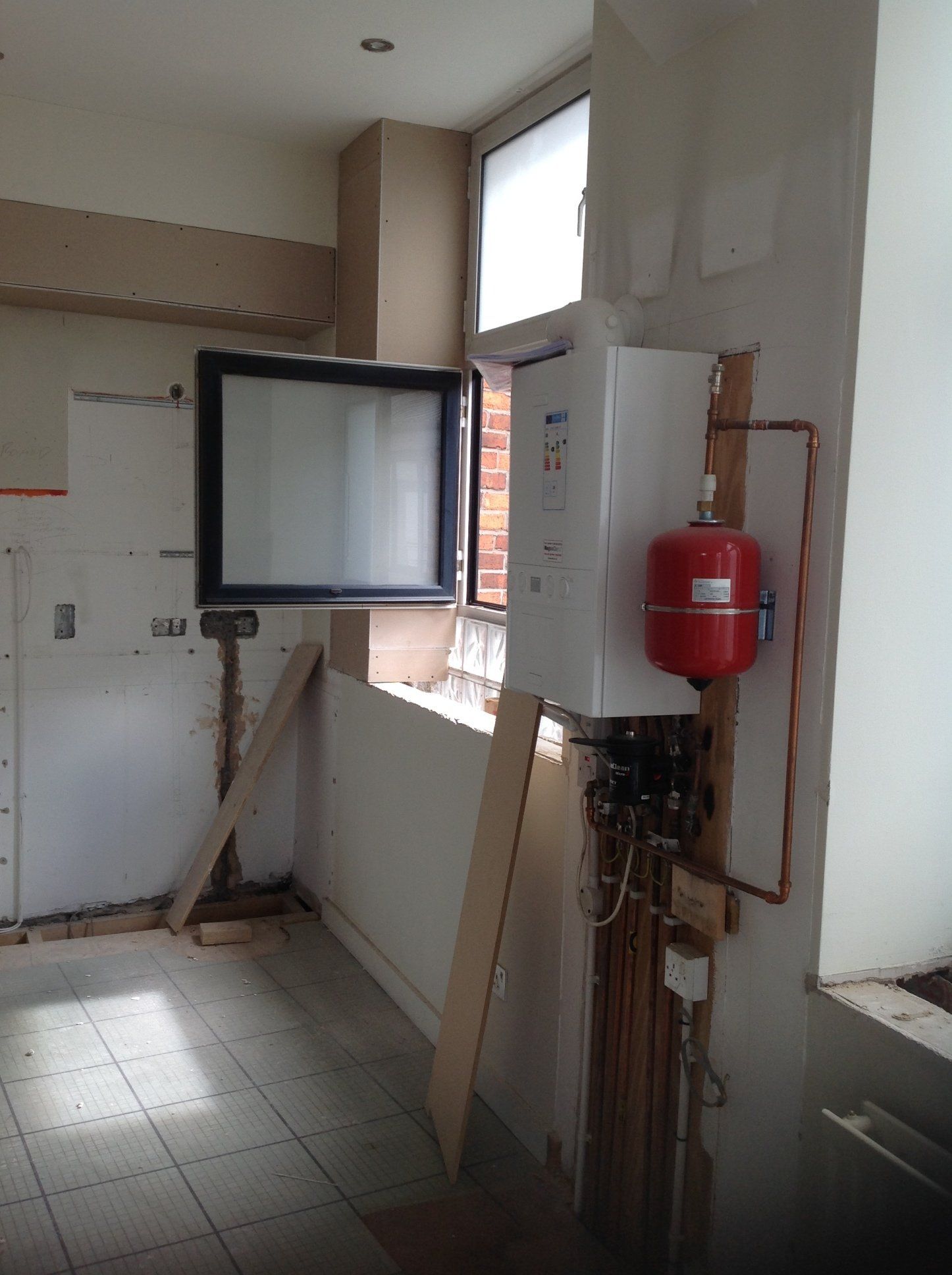 An empty room with a boiler and a window