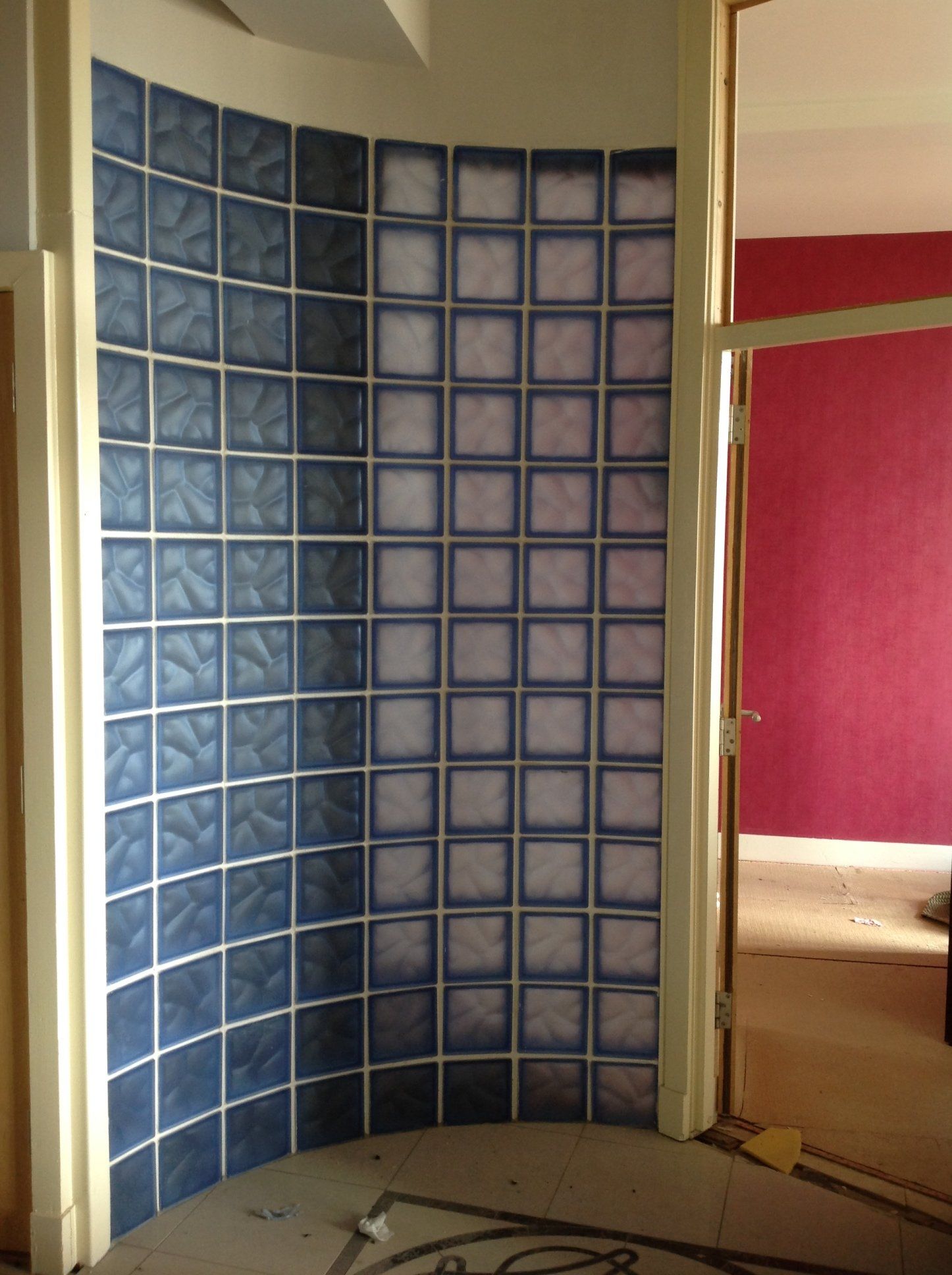 A corner of a room with blue and white tiles